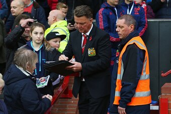 MANCHESTER, ENGLAND - NOVEMBER 07:  Louis van Gaal Manager of Manchester United signs autographs for fans prior to the Barclays Premier League match between Manchester United and West Bromwich Albion at Old Trafford on November 7, 2015 in Manchester, Engl