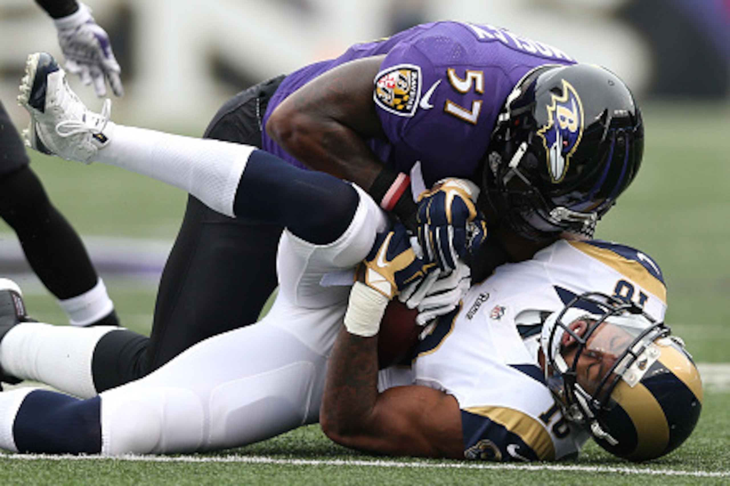 BALTIMORE, MD - NOVEMBER 22: Wide receiver Kenny Britt #18 of the St. Louis Rams is tackled by inside linebacker C.J. Mosley #57 of the Baltimore Ravens in the first quarter at M&T Bank Stadium on November 22, 2015 in Baltimore, Maryland. (Photo by Patric