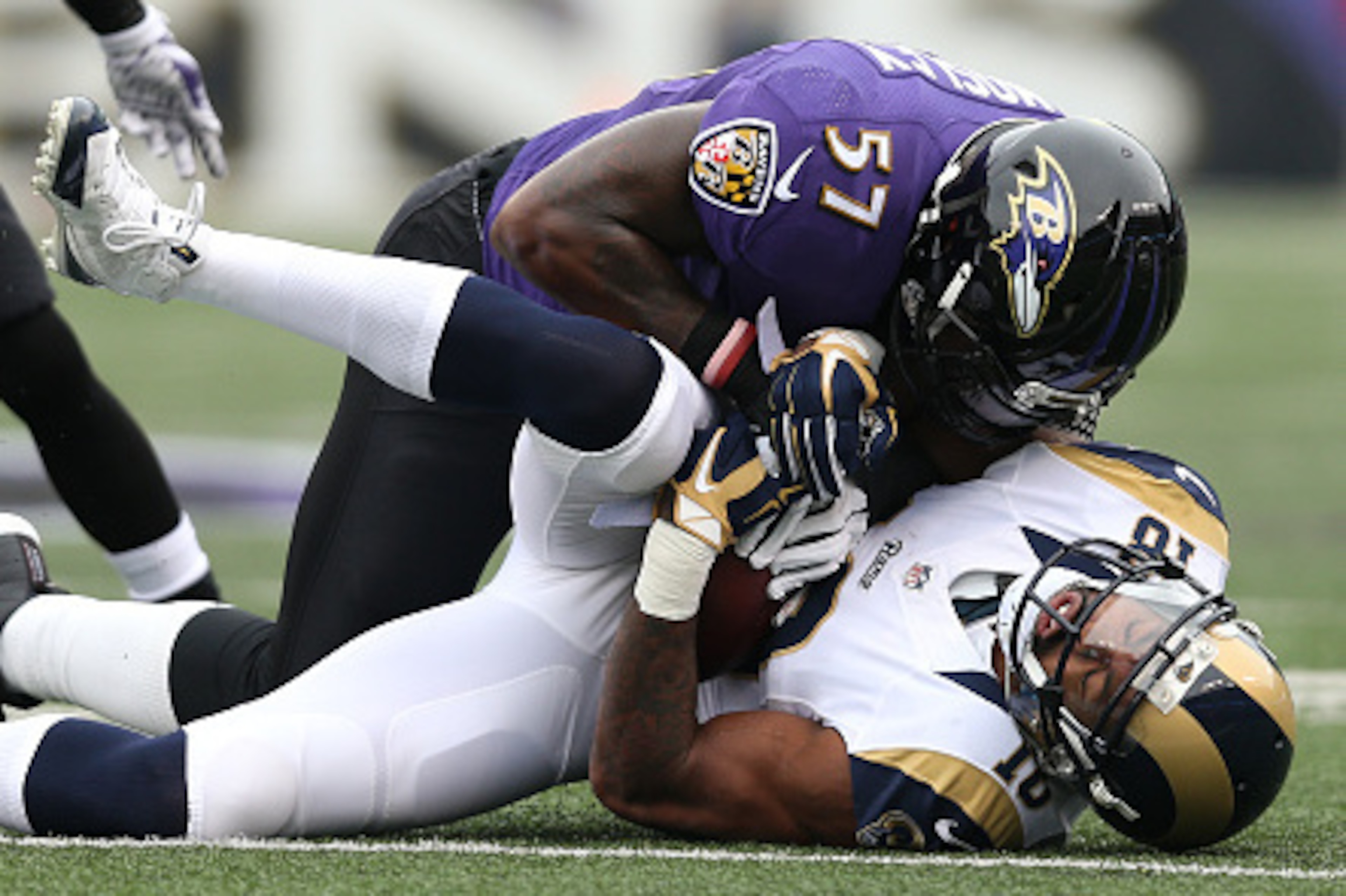 BALTIMORE, MD - NOVEMBER 22: Wide receiver Kenny Britt #18 of the St. Louis Rams is tackled by inside linebacker C.J. Mosley #57 of the Baltimore Ravens in the first quarter at M&T Bank Stadium on November 22, 2015 in Baltimore, Maryland. (Photo by Patric