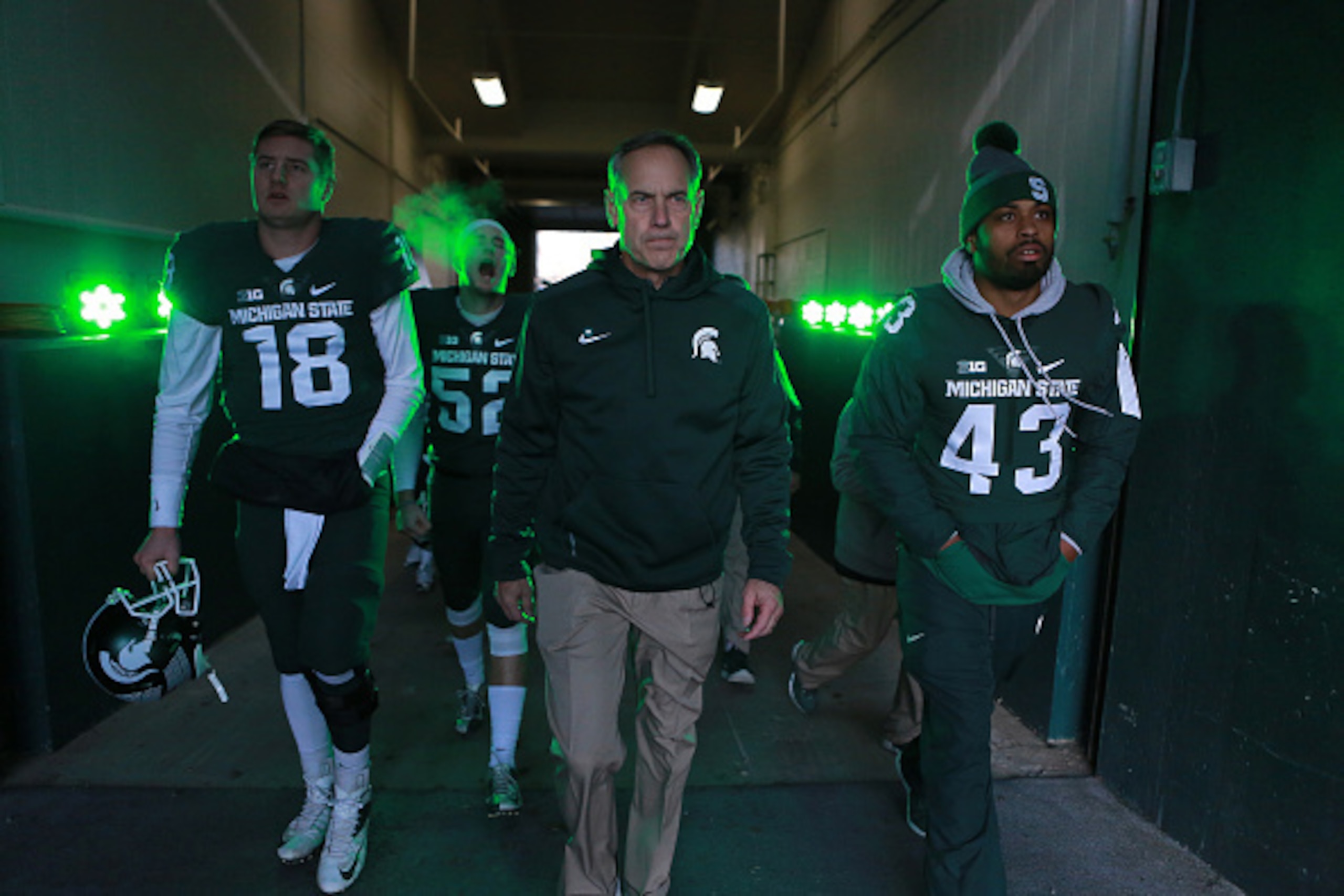 EAST LANSING, MI - NOVEMBER 28: Head coach Mark Dantonio of the Michigan State Spartans leads his team onto the field prior to a game against the Penn State Nittany Lions at Spartan Stadium on November 28, 2015 in East Lansing, Michigan. (Photo by Rey Del