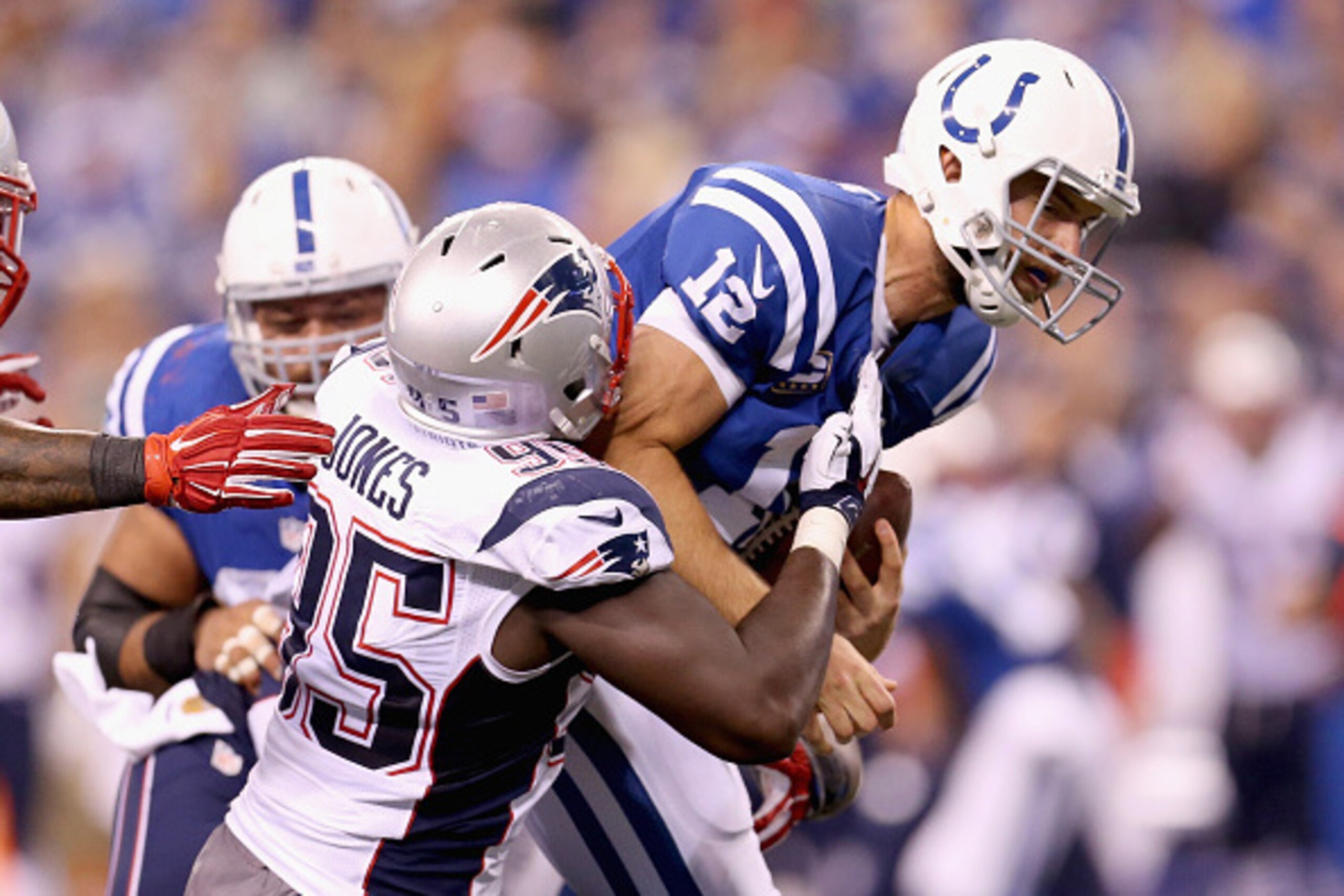 INDIANAPOLIS, IN - OCTOBER 18:  Andrew Luck #12 of the Indianapolis Colts is sacked by Chandler Jones #95 and Dominique Easley #99 of the New England Patriots at Lucas Oil Stadium on October 18, 2015 in Indianapolis, Indiana.  (Photo by Andy Lyons/Getty I
