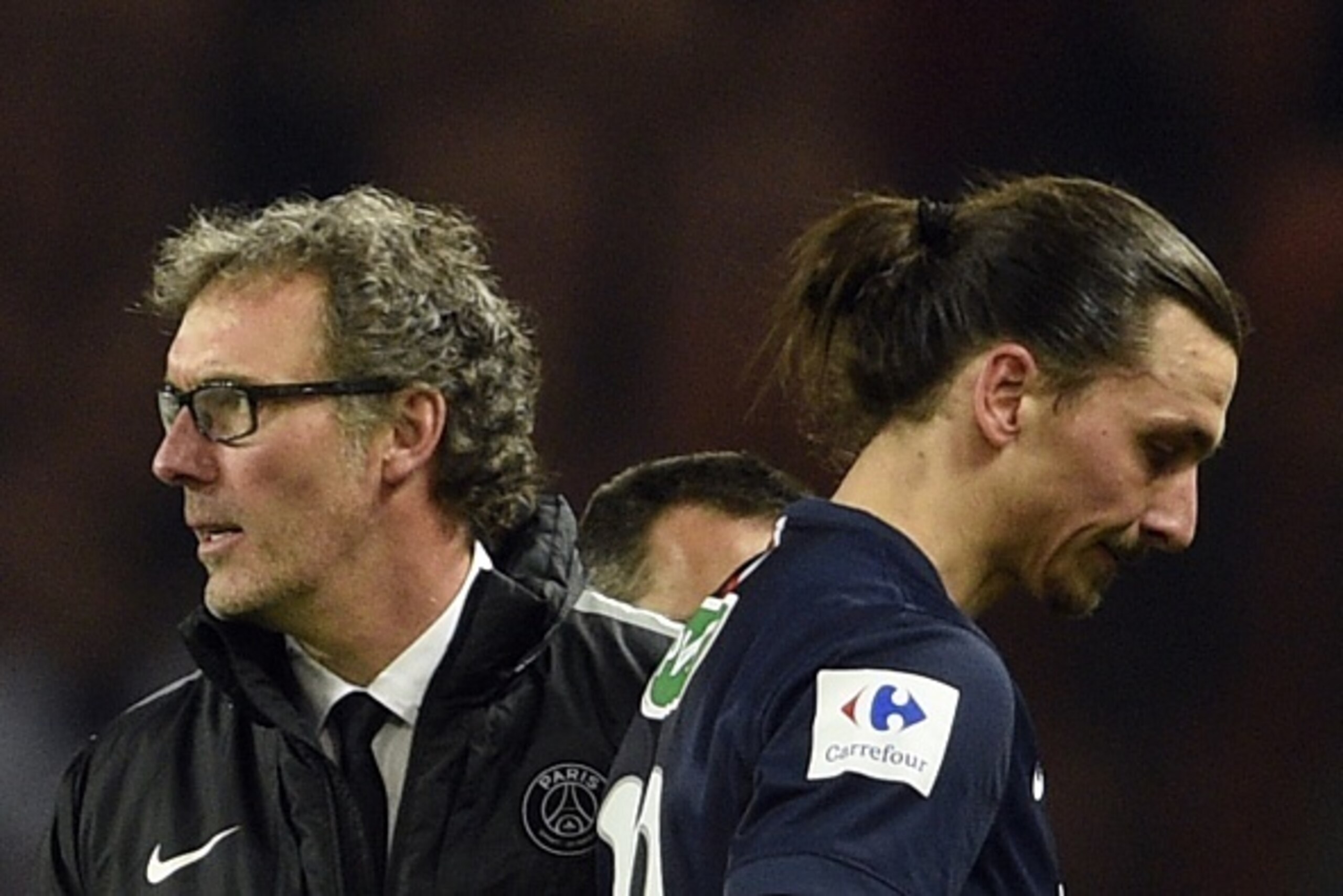 Paris Saint-Germain's Swedish forward Zlatan Ibrahimovic (R) and Paris Saint-Germain head coach Laurent Blanc (L) leave the pitch on April 8, 2015 after a semi-final French Cup football match between Paris Saint-Germain (PSG) and Saint-Etienne (ASSE) at t