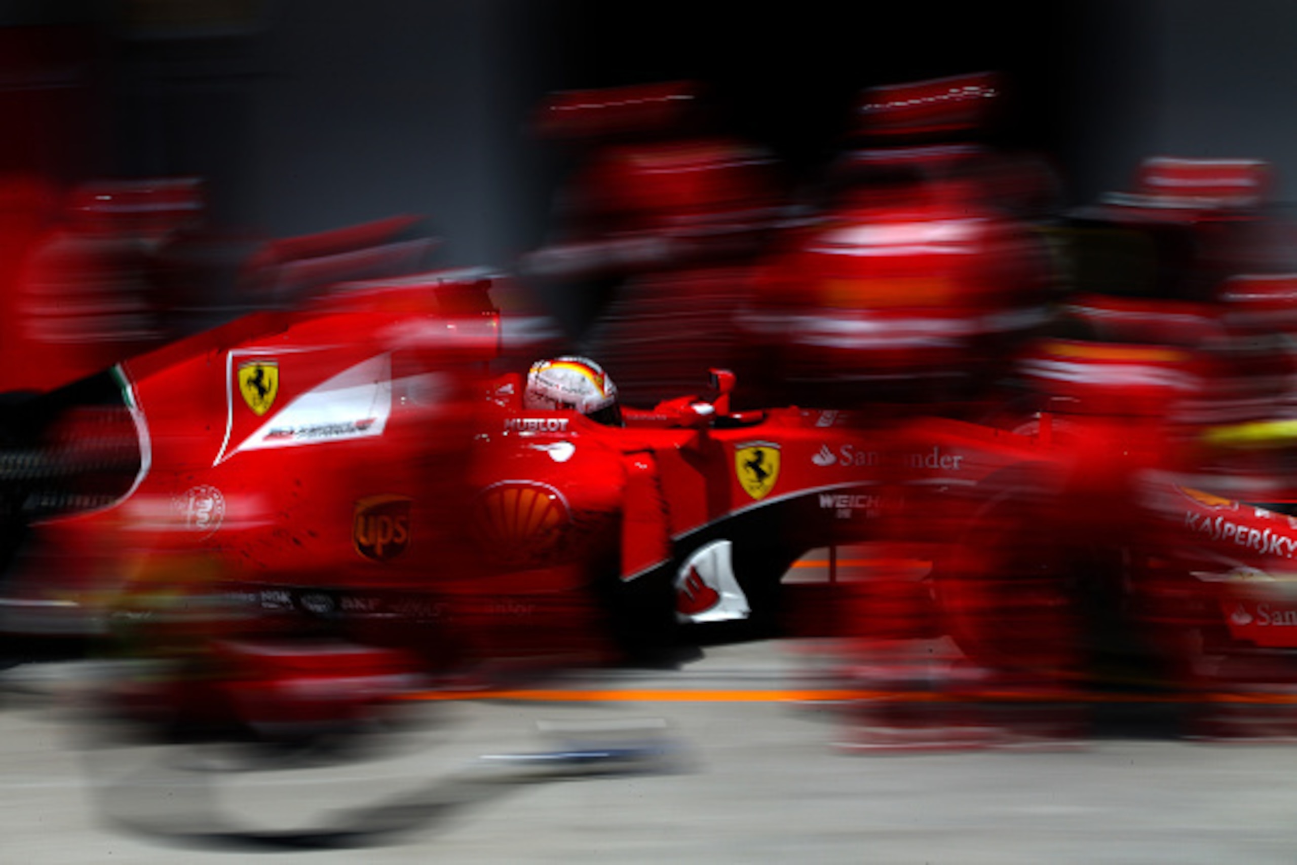SAO PAULO, BRAZIL - NOVEMBER 15:  Sebastian Vettel of Germany and Ferrari makes a pit stop during the Formula One Grand Prix of Brazil at Autodromo Jose Carlos Pace on November 15, 2015 in Sao Paulo, Brazil.  (Photo by Mark Thompson/Getty Images)