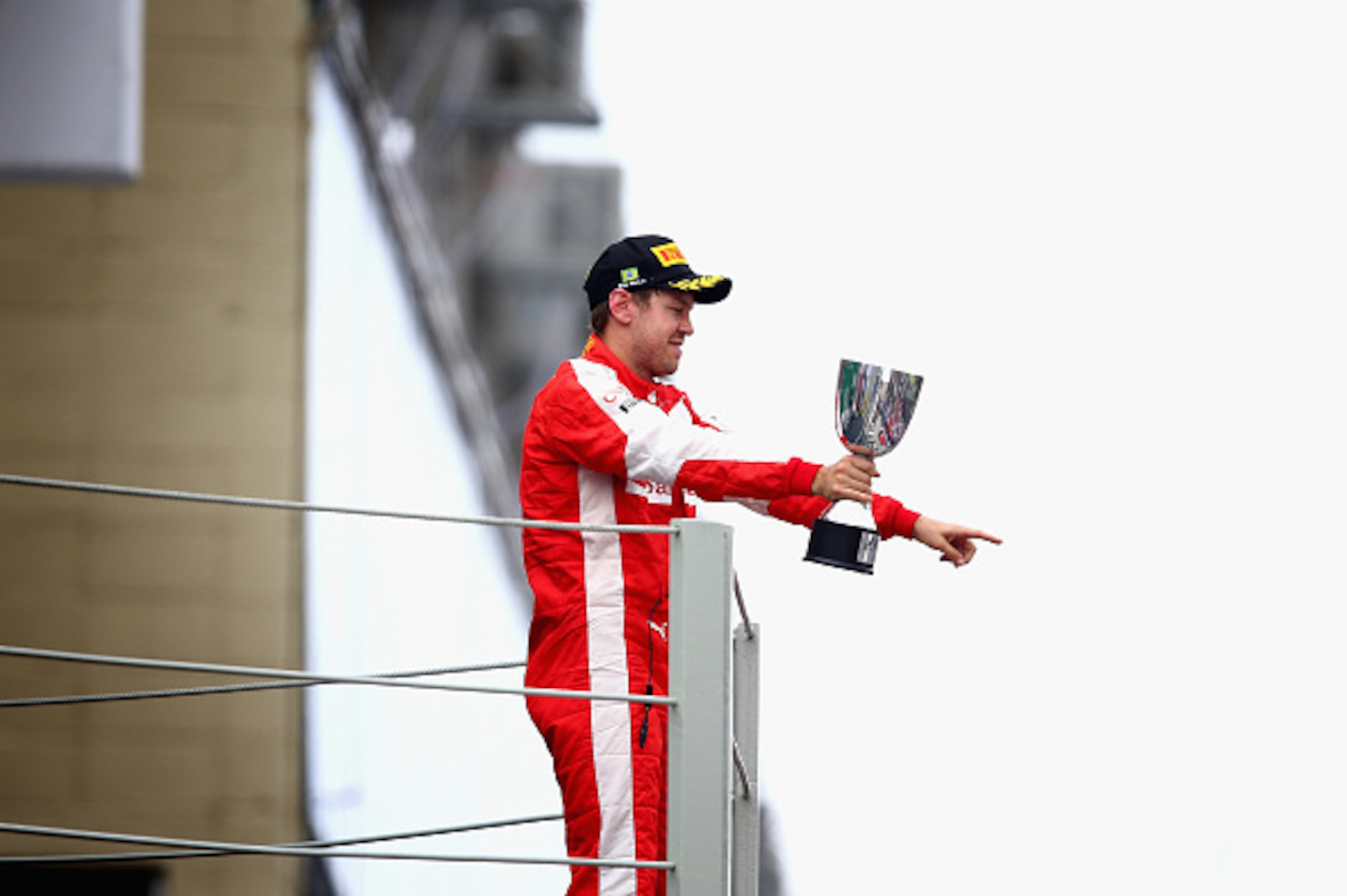 SAO PAULO, BRAZIL - NOVEMBER 15:  Sebastian Vettel of Germany and Ferrari celebrates on the podium after finishing third in the Formula One Grand Prix of Brazil at Autodromo Jose Carlos Pace on November 15, 2015 in Sao Paulo, Brazil.  (Photo by Clive Maso