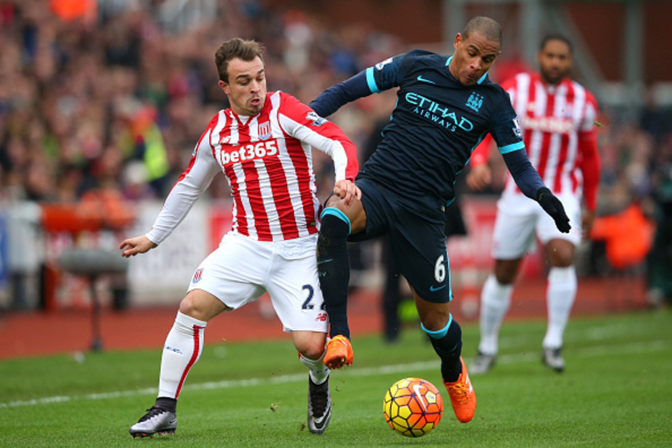 STOKE ON TRENT, ENGLAND - DECEMBER 05:  Xherdan Shaqiri of Stoke City and Fernando of Manchester City compete for the ball during the Barclays Premier League match between Stoke City and Manchester City at Britannia Stadium on December 5, 2015 in Stoke on