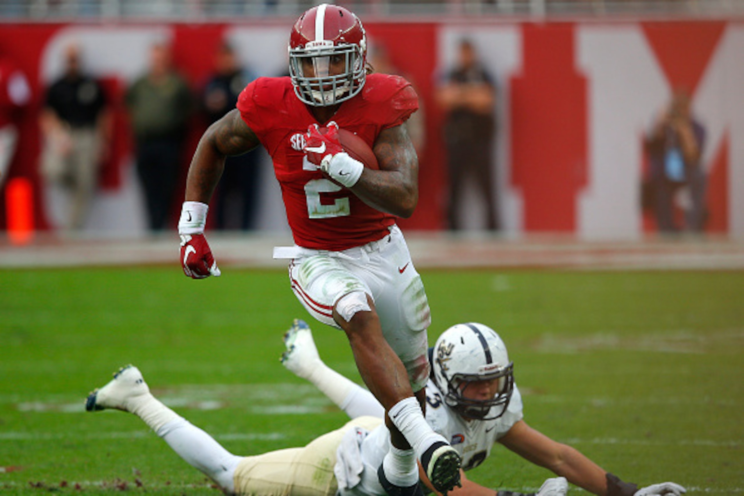 TUSCALOOSA, AL - NOVEMBER 21:  Derrick Henry #2 of the Alabama Crimson Tide rushes past Zane Cruz #43 of the Charleston Southern Buccaneers at Bryant-Denny Stadium on November 21, 2015 in Tuscaloosa, Alabama.  (Photo by Kevin C. Cox/Getty Images)