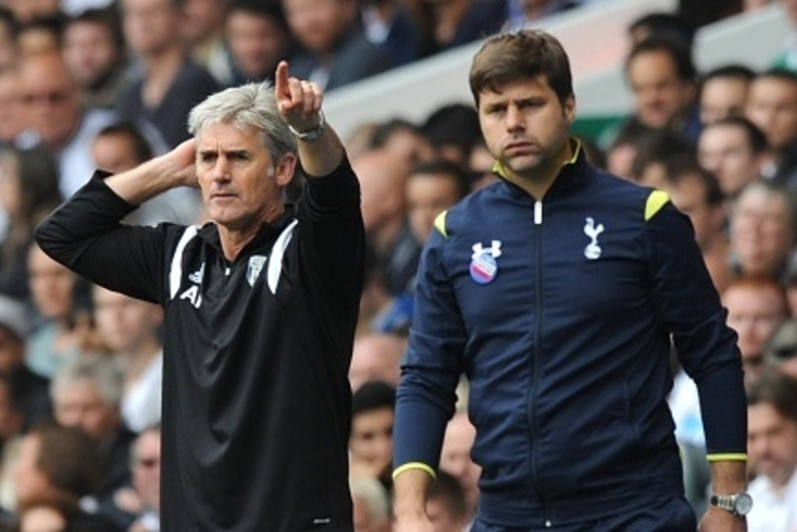 Tottenham Hotspur's Argentinian manager Mauricio Pochettino (R) looks on while West Bromwich Albion's Scottish manager Alan Irvine shouts to his players during the English Premier League football match between Tottenham Hotspur and West Bromwich Albion at