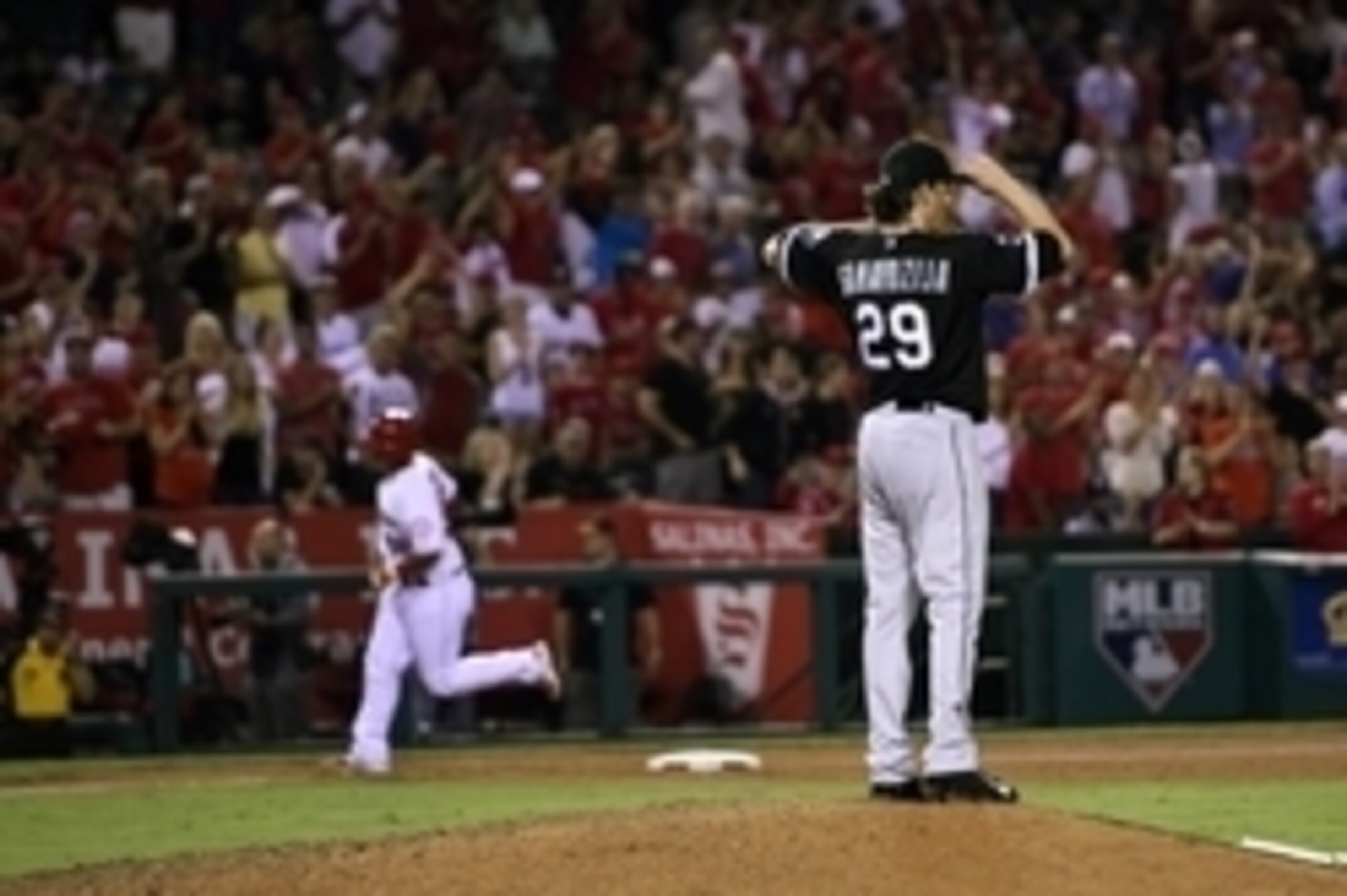 Aug 19, 2015; Anaheim, CA, USA; Chicago White Sox starting pitcher Jeff Samardzija (right) fixes his hat as Los Angeles Angels catcher Carlos Perez (58) rounds third after hitting a solo home run during the sixth inning at Angel Stadium of Anaheim. Mandat Aug 19, 2015; Anaheim, CA, USA; Chicago White Sox starting pitcher Jeff Samardzija (right) fixes his hat as Los Angeles Angels catcher Carlos Perez (58) rounds third after hitting a solo home run during the sixth inning at Angel Stadium of Anaheim. Mandat