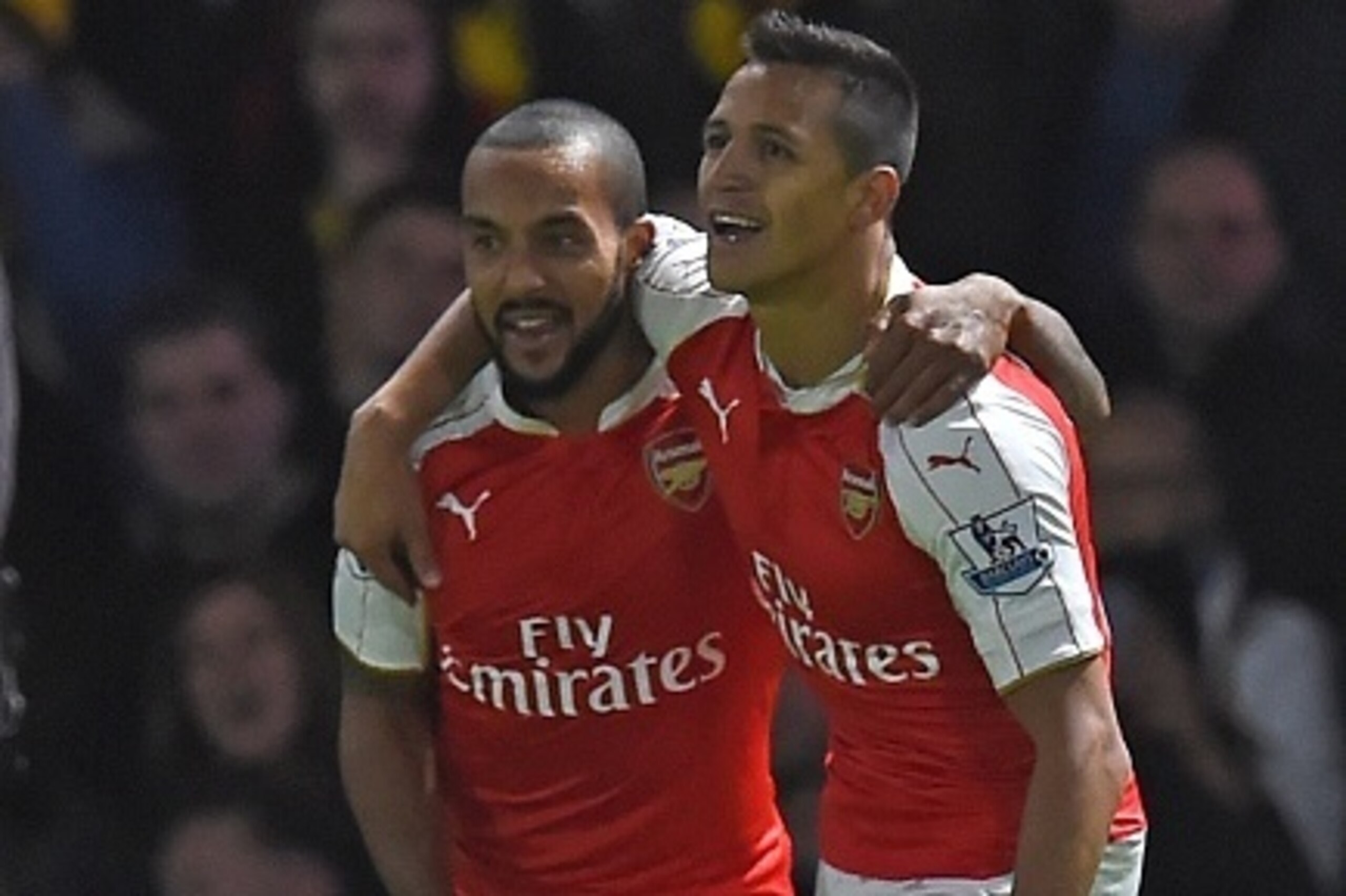 Arsenal's Chilean striker Alexis Sanchez (R) celebrates with Arsenal's English midfielder Theo Walcott after scoring the opening goal of the English Premier League football match between Watford and Arsenal at Vicarage Road Stadium in Watford, north of Lo