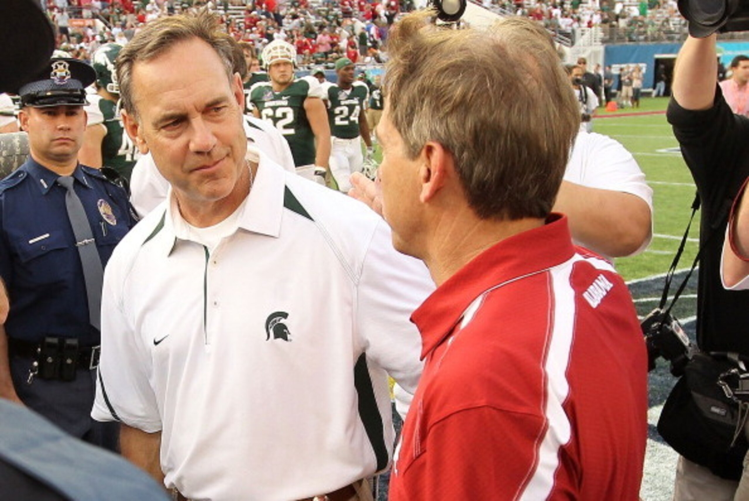 ORLANDO, FL - JANUARY 01:  Alabama Crimson Tide Head Coach Nick Saban greets Michigan State Spartans Head Coach Mark Dantonio after winning the Capitol One Bowl against at the Florida Citrus Bowl on January 1, 2011 in Orlando, Florida.  (Photo by Mike Ehr