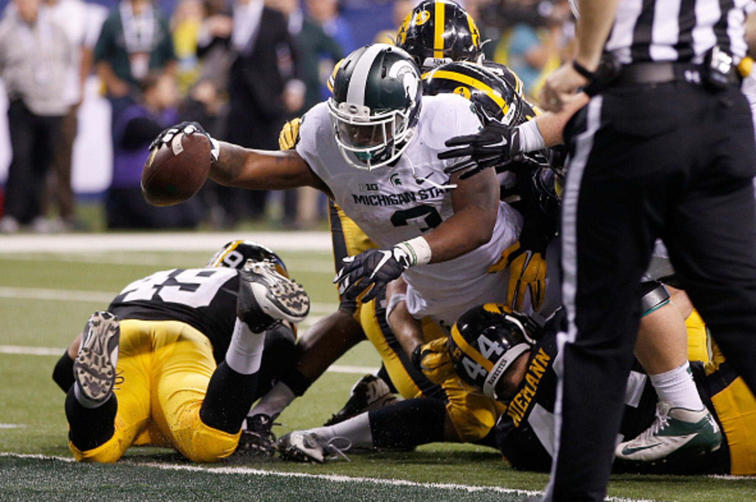 INDIANAPOLIS, IN - DECEMBER 05:  LJ Scott #3 of the Michigan State Spartans reaches into the end zone against the Iowa Hawkeyes in the Big Ten Championship at Lucas Oil Stadium on December 5, 2015 in Indianapolis, Indiana.  (Photo by Joe Robbins/Getty Ima