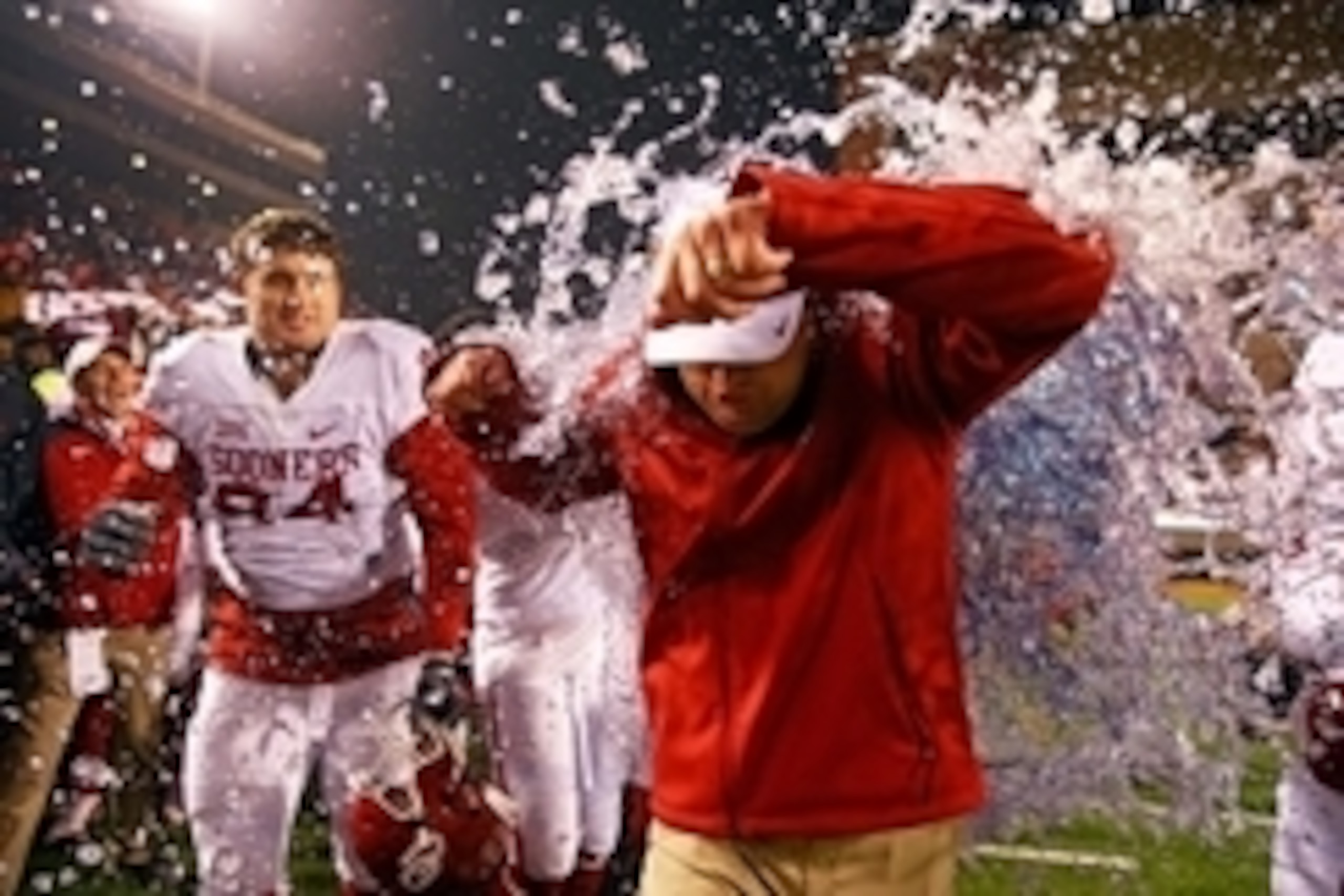 Nov 28, 2015; Stillwater, OK, USA; Oklahoma Sooners head coach Bob Stoops reacts as he is dunked by teammates with the Gatorade cooler in the closing seconds of the game against the Oklahoma State Cowboys at Boone Pickens Stadium. The Sooners defeated the