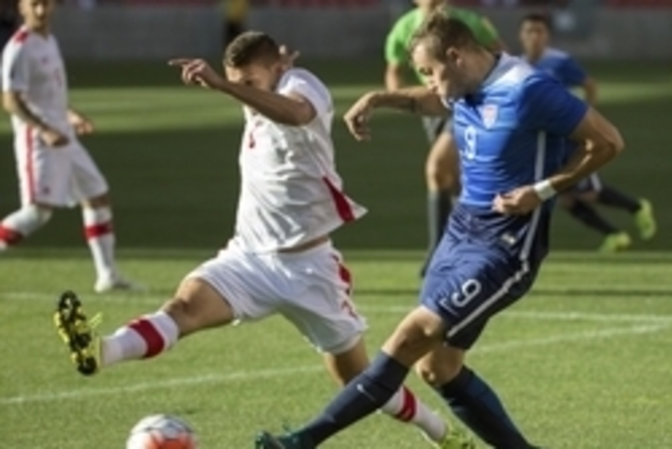 Oct 13, 2015; Sandy, UT, USA; United States forward Jordan Morris (9) passes the ball across the goal while being defended by Canada midfielder Giuliano Frano (3) during the first half at Rio Tinto Stadium. United States won the game 2-0. Mandatory Credit