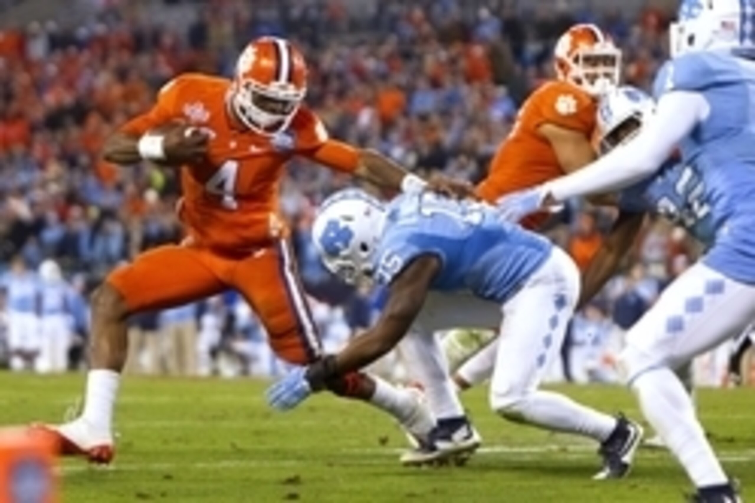 Dec 5, 2015; Charlotte, NC, USA; Clemson Tigers quarterback Deshaun Watson (4) carries the ball as North Carolina Tar Heels safety Donnie Miles (15) tackles during the second half in the ACC football championship game at Bank of America Stadium. Mandatory