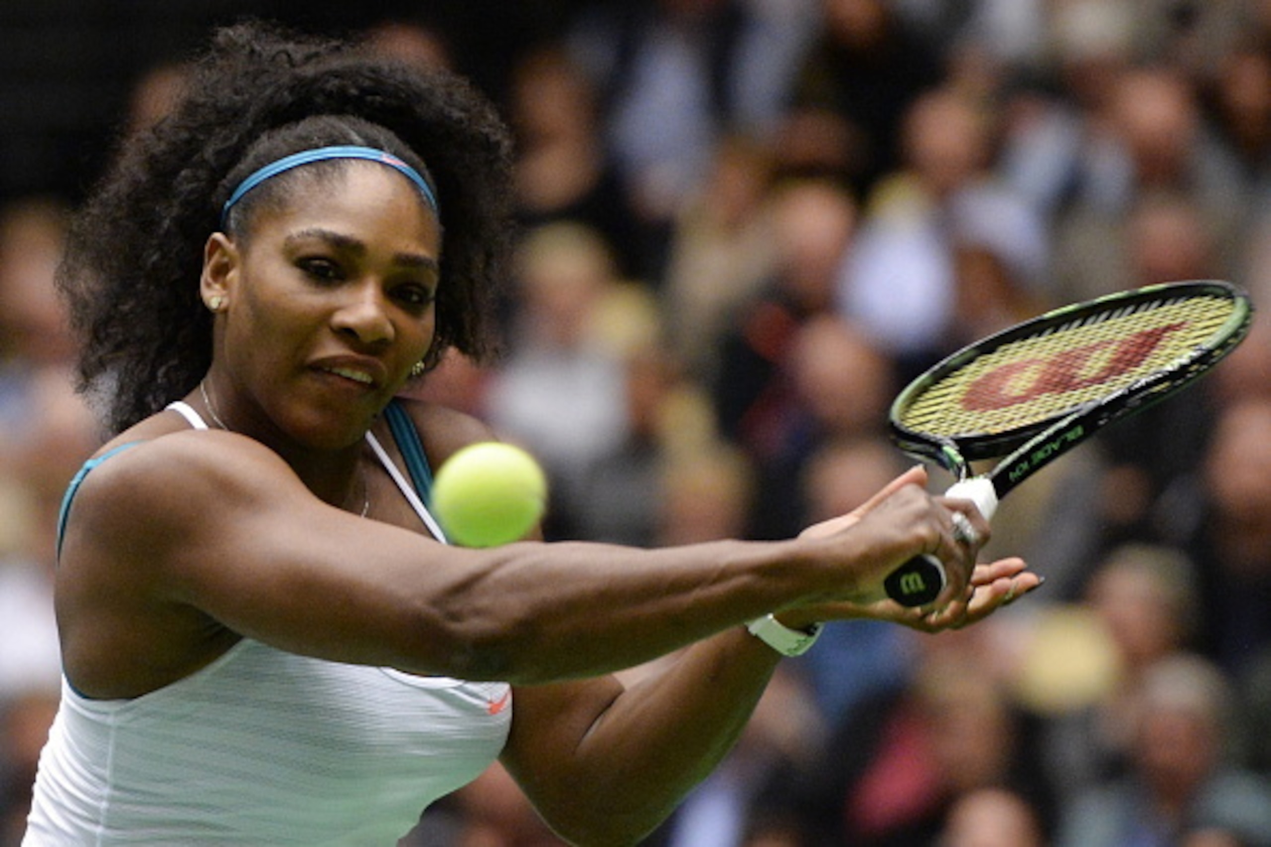 Serena Williams from the US returns a ball to Danish tennis player Caroline Wozniacki during their Champions Battle exhibition game in benefit of the development of Danish sports on November 26, 2015 in Herning, Denmark. Wozniacki won the match 6-3 6-4. A