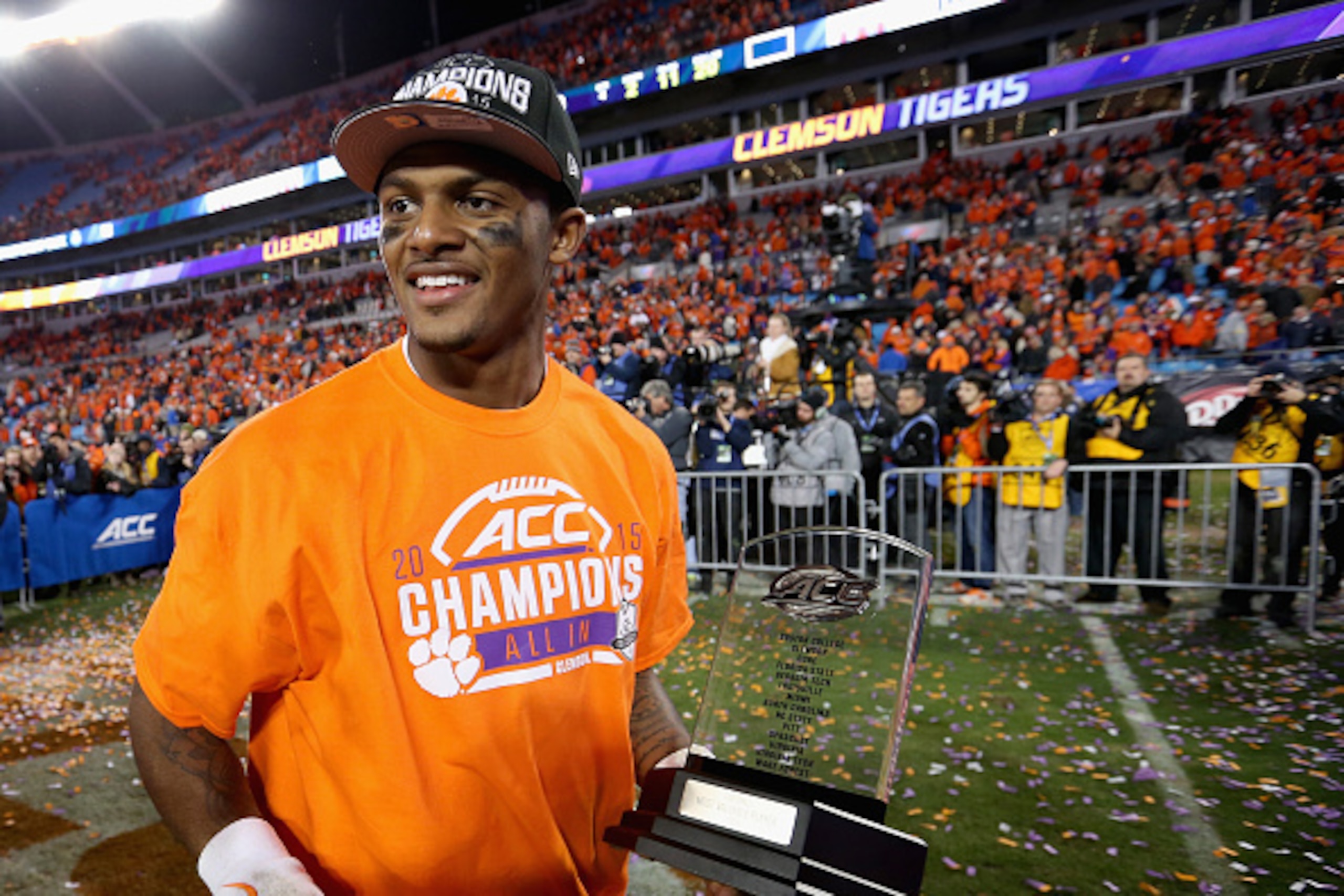 CHARLOTTE, NC - DECEMBER 05:  Deshaun Watson #4 of the Clemson Tigers celebrates as he holds the most valuable player trophy after defeating the North Carolina Tar Heels 45-37 at the Atlantic Coast Conference Football Championship at Bank of America Stadi