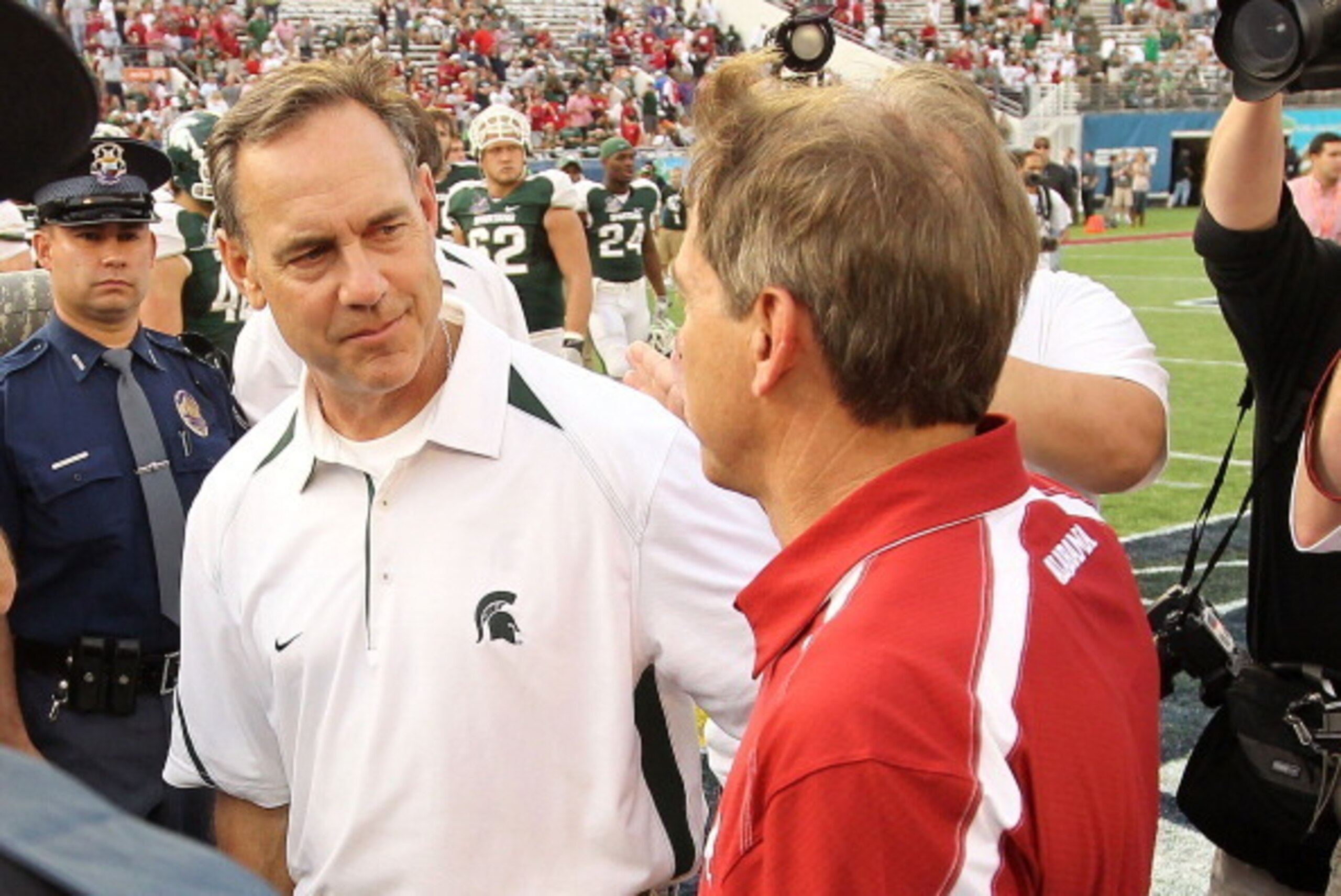 ORLANDO, FL - JANUARY 01:  Alabama Crimson Tide Head Coach Nick Saban greets Michigan State Spartans Head Coach Mark Dantonio after winning the Capitol One Bowl against at the Florida Citrus Bowl on January 1, 2011 in Orlando, Florida.  (Photo by Mike Ehr