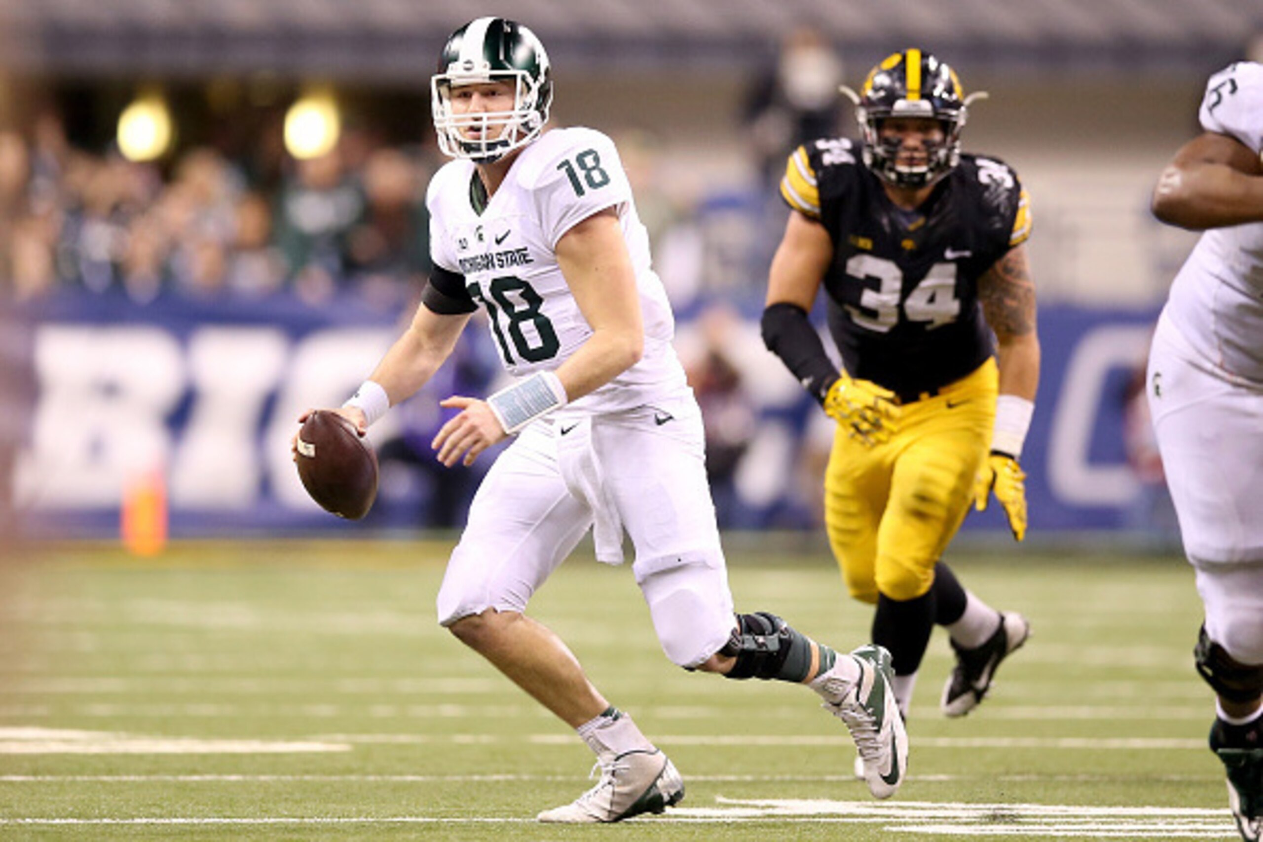 INDIANAPOLIS, IN - DECEMBER 05:  Connor Cook #18 of the Michigan State Spartans runs with the ball against the Iowa Hawkeyes in the Big Ten Championship at Lucas Oil Stadium on December 5, 2015 in Indianapolis, Indiana.  (Photo by Andy Lyons/Getty Images)