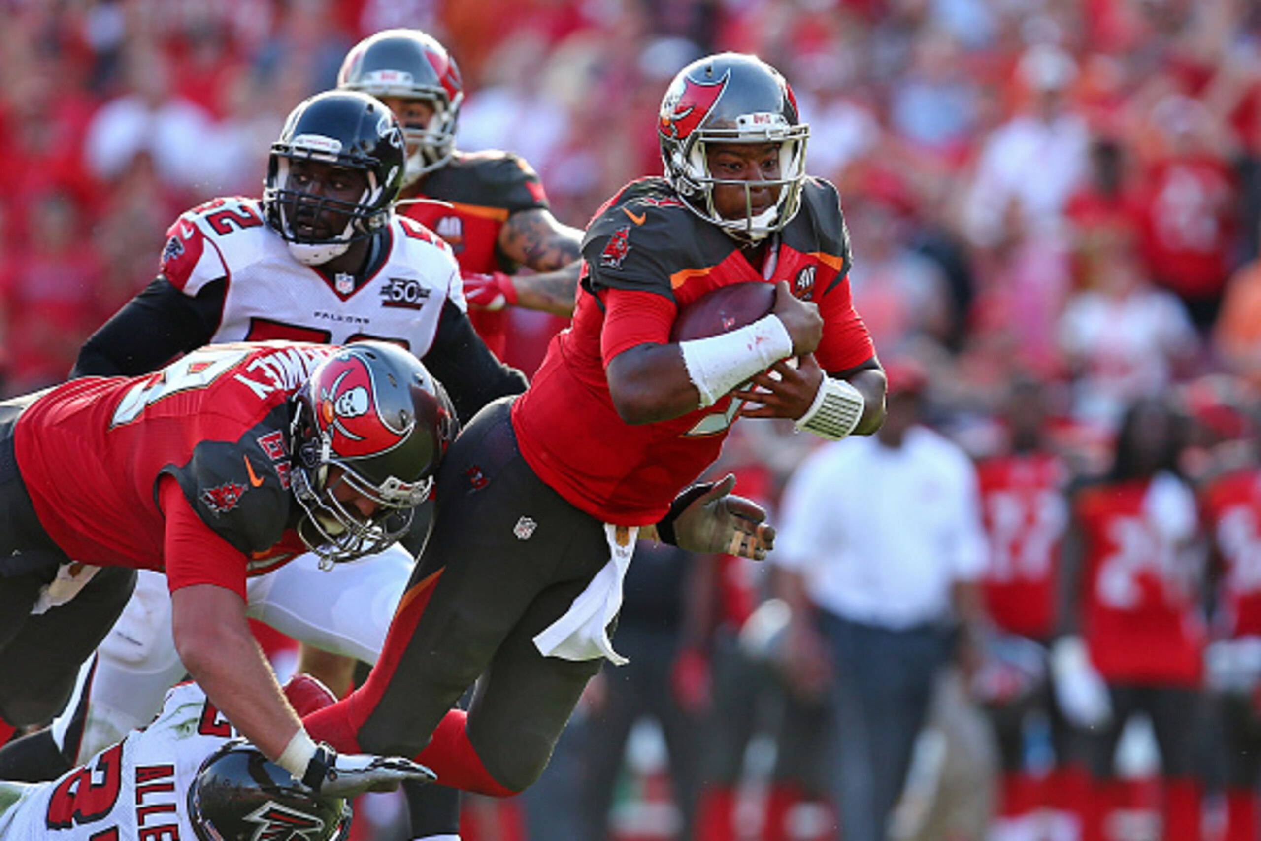 TAMPA, FL - DECEMBER 06:  Jameis Winston #3 of the Tampa Bay Buccaneers is tripped up by Kemal Ishmael #36 of the Atlanta Falcons during the second half of the game at Raymond James Stadium on December 6, 2015 in Tampa, Florida.  (Photo by Rob Foldy/Getty