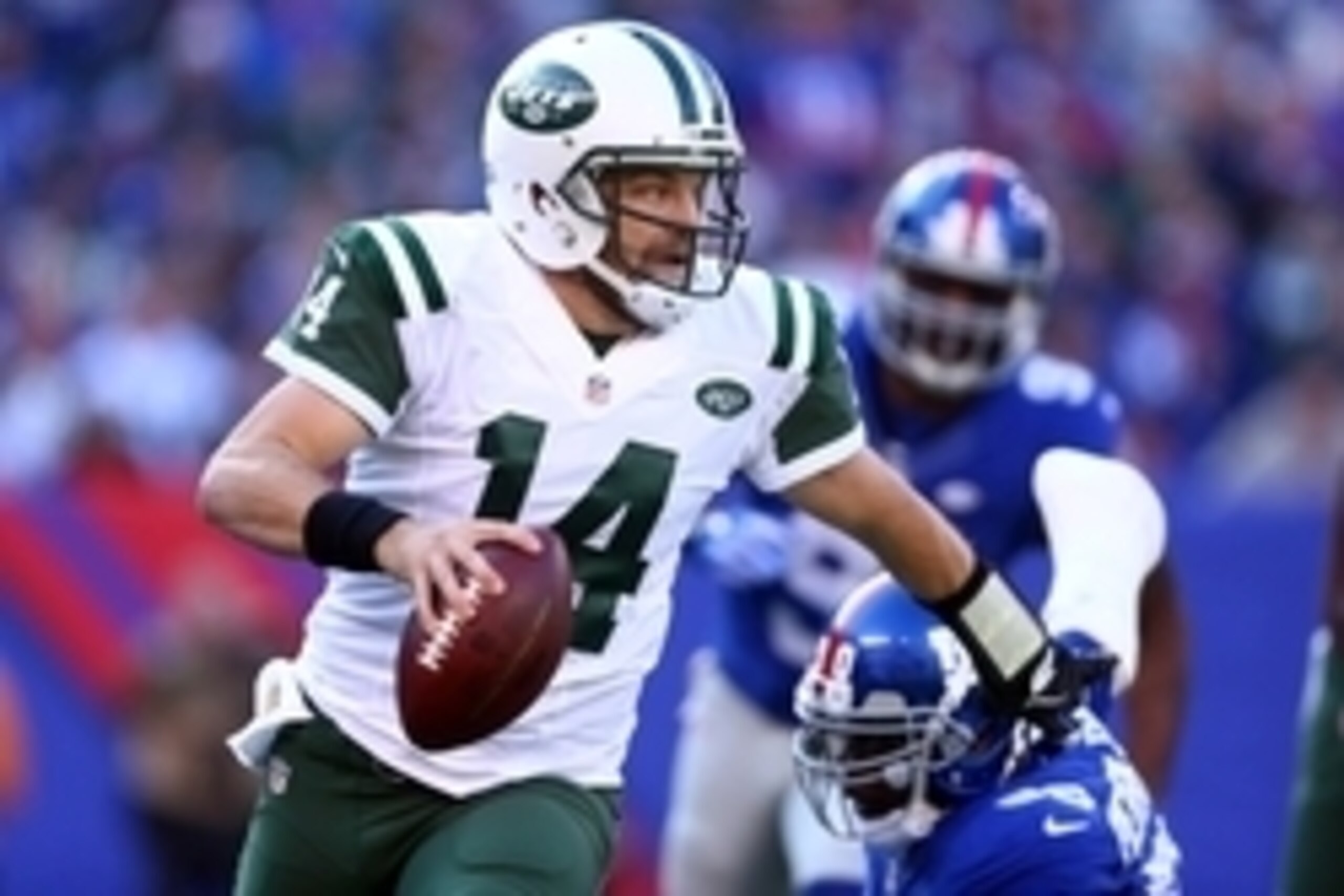 Dec 6, 2015; East Rutherford, NJ, USA; New York Jets quarterback Ryan Fitzpatrick (14) scrambles with the ball against the New York Giants during the first quarter at MetLife Stadium. Mandatory Credit: Brad Penner-USA TODAY Sports