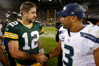 GREEN BAY, WI - SEPTEMBER 20:  Quarterbacks Aaron Rodgers #12 of the Green Bay Packers and Russell Wilson #3 of the Seattle Seahawks shake hands following the NFL game at Lambeau Field on September 20, 2015 in Green Bay, Wisconsin.  The Packers defeated t