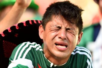FORTALEZA, BRAZIL - JUNE 29:  A dejected Mexico fan reacts after being defeated by the Netherlands 2-1 during the 2014 FIFA World Cup Brazil Round of 16 match between Netherlands and Mexico at Castelao on June 29, 2014 in Fortaleza, Brazil.  (Photo by Lau