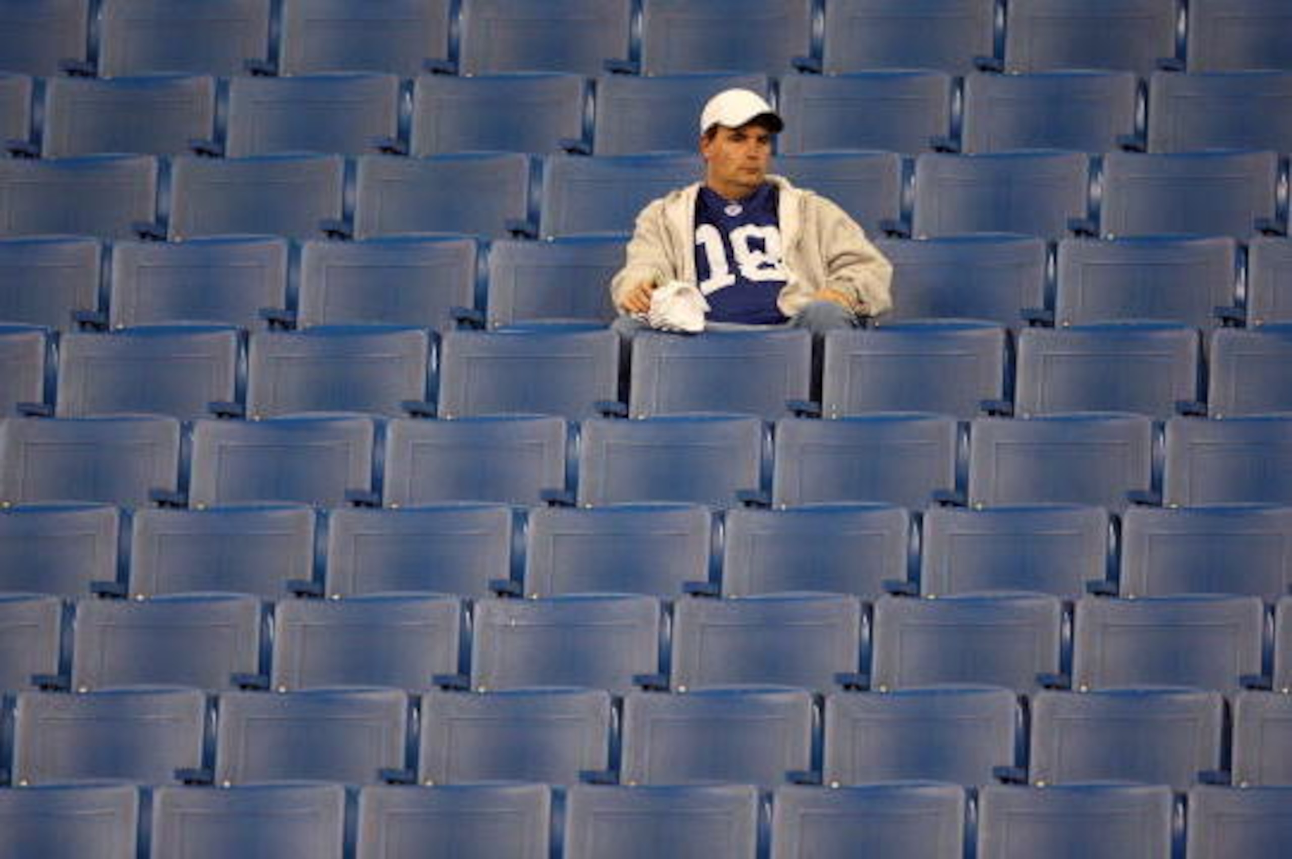 INDIANAPOLIS - JANUARY 13:  A lone fan of the Indianapolis Colts sits in the stands dejected after the Colts lost 28-24 against the San Diego Chargers during their AFC Divisional Playoff game at the RCA Dome on January 13, 2008 in Indianapolis, Indiana.  