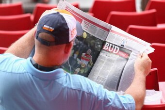 SYDNEY, AUSTRALIA - MARCH 15:  A Giants fan reads a newspaper story about Lance Franklin of the Swans before the round one AFL match between the Greater Western Sydney Giants and the Sydney Swans at Spotless Stadium on March 15, 2014 in Sydney, Australia.