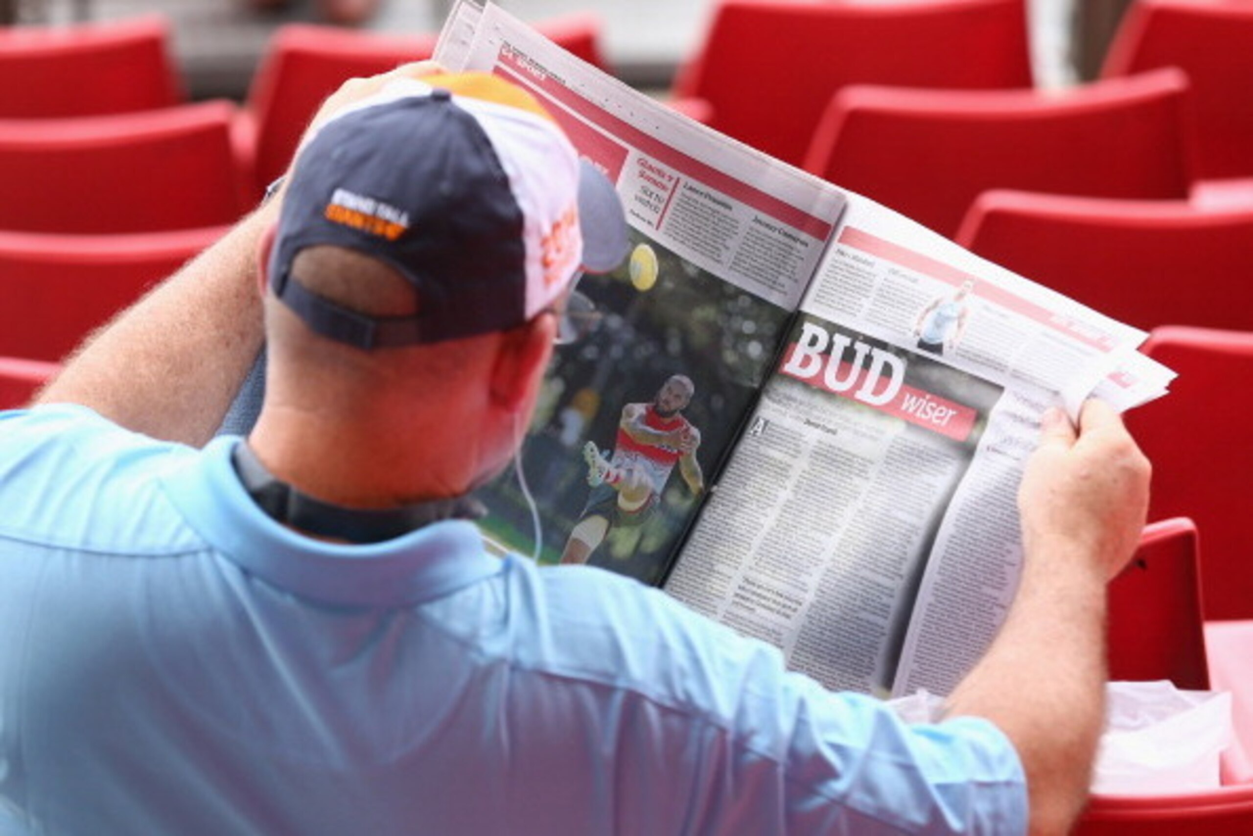 SYDNEY, AUSTRALIA - MARCH 15:  A Giants fan reads a newspaper story about Lance Franklin of the Swans before the round one AFL match between the Greater Western Sydney Giants and the Sydney Swans at Spotless Stadium on March 15, 2014 in Sydney, Australia.