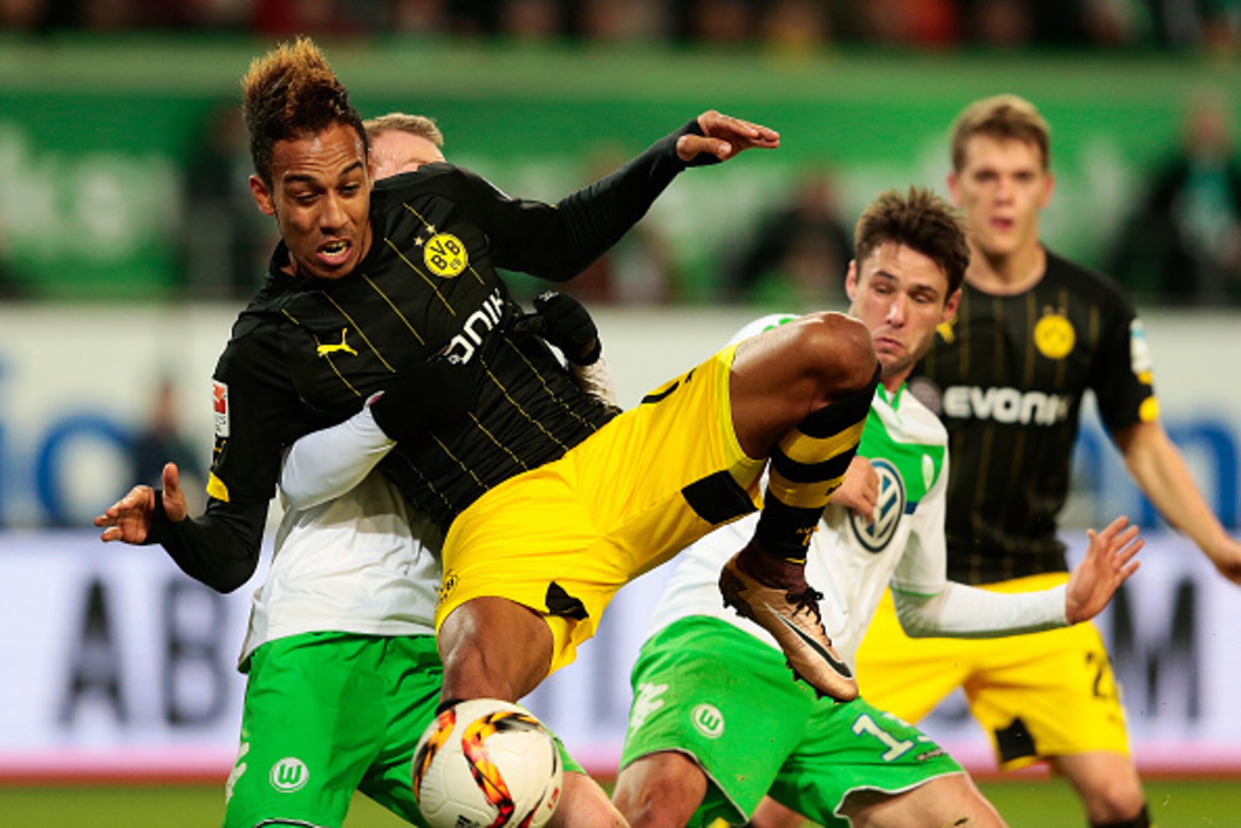 WOLFSBURG, GERMANY - DECEMBER 05: Maximilian Arnold (L) of Wolfsburg and Patrick Emerick Aubameyang (C) of Dortmund compete for the ball during the First Bundesliga match at between VfL Wolfsburg and Borussia Dortmund at Volkswagen Arena on December 5, 20