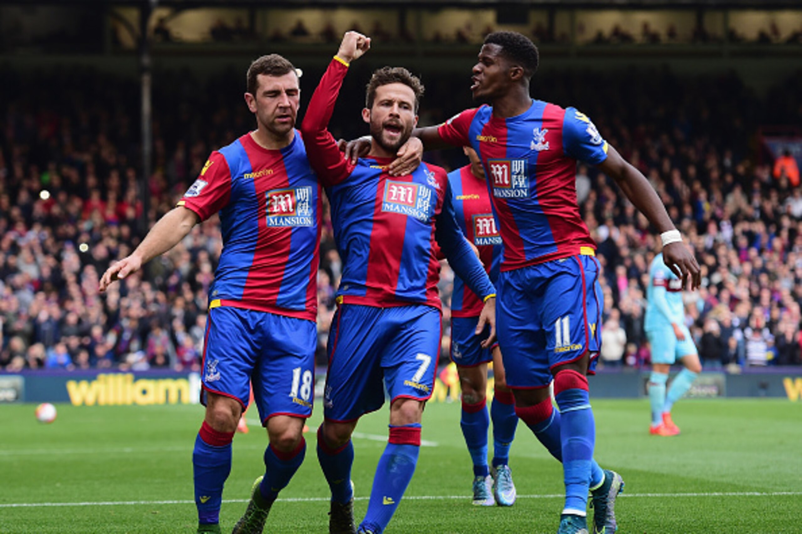 LONDON, ENGLAND - OCTOBER 17:  Yohan Cabaye (C) of Crystal Palace celebrates scoring his team's first goal with his team mates James McArthur (L) and Wilfried Zaha (R) during the Barclays Premier League match between Crystal Palace and West Ham United at 