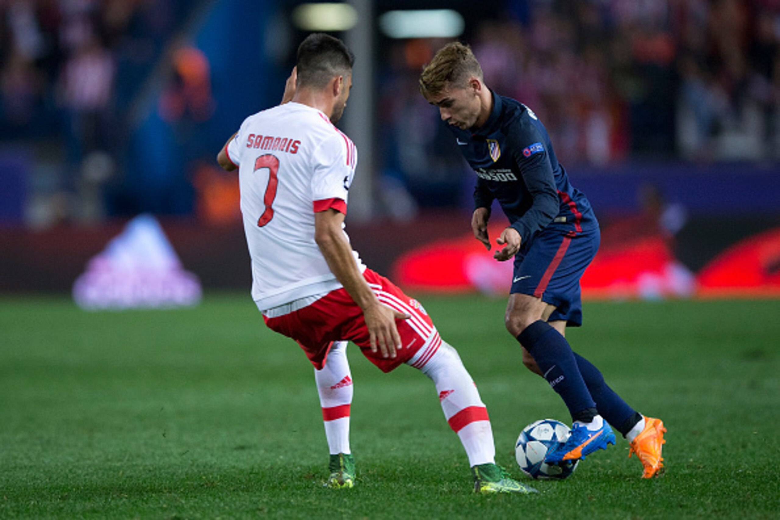 MADRID, SPAIN - SEPTEMBER 30: Antoine Griezmann (R) of Atletico de Madrid competes for the ball with Andreas Samaris (L) of SL Benfica during the UEFA Champions League Group C match between Club Atletico de Madrid and SL Benfica at Vicente Calderon Stadiu MADRID, SPAIN - SEPTEMBER 30: Antoine Griezmann (R) of Atletico de Madrid competes for the ball with Andreas Samaris (L) of SL Benfica during the UEFA Champions League Group C match between Club Atletico de Madrid and SL Benfica at Vicente Calderon Stadiu