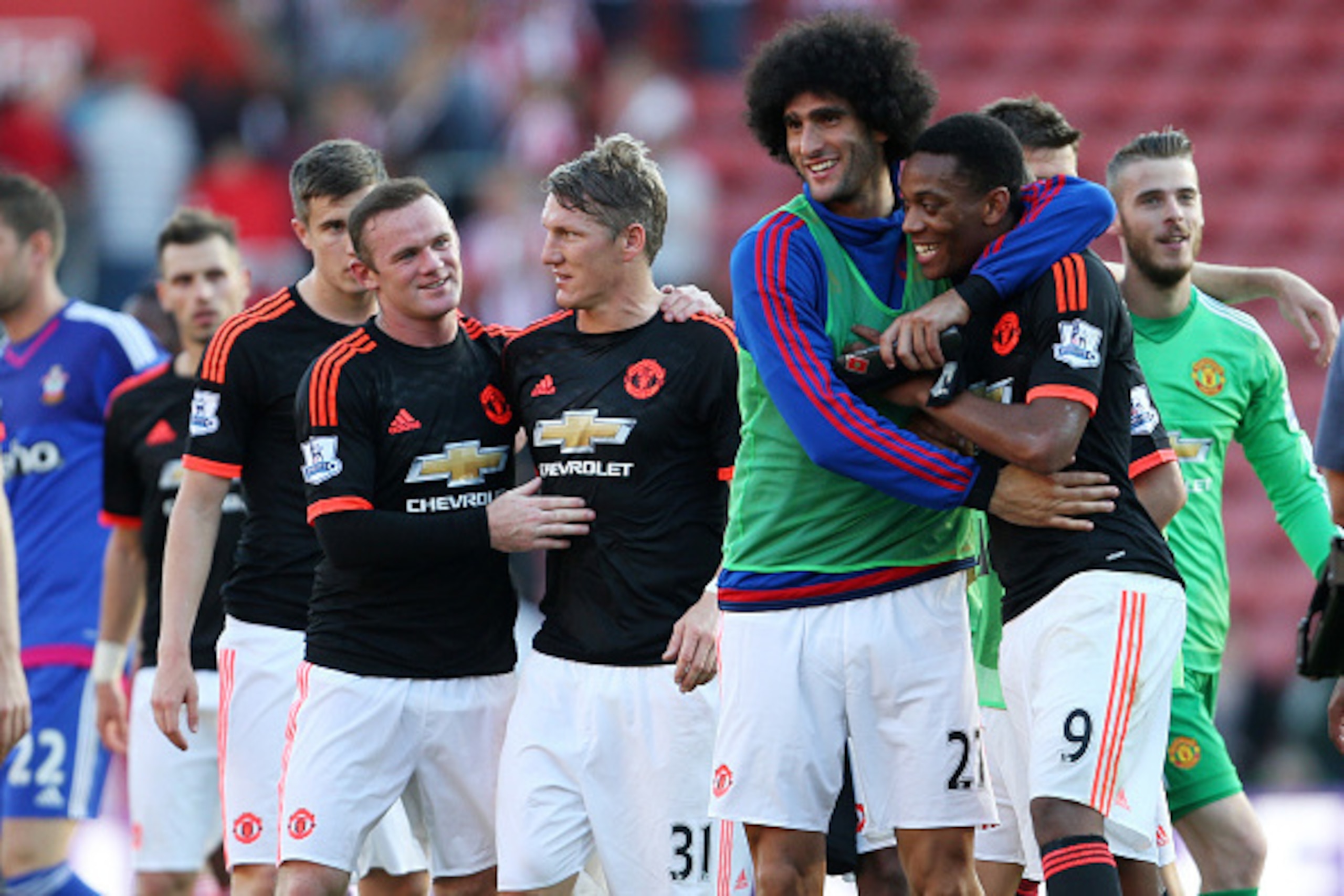 SOUTHAMPTON, ENGLAND - SEPTEMBER 20:  Marouane Fellaini of Manchester United hugs team mate Anthony Martial while Wayne Rooney hugs Bastian Schweinsteiger after the Barclays Premier League match at St Mary's stadium between Southampton and Manchester Unit
