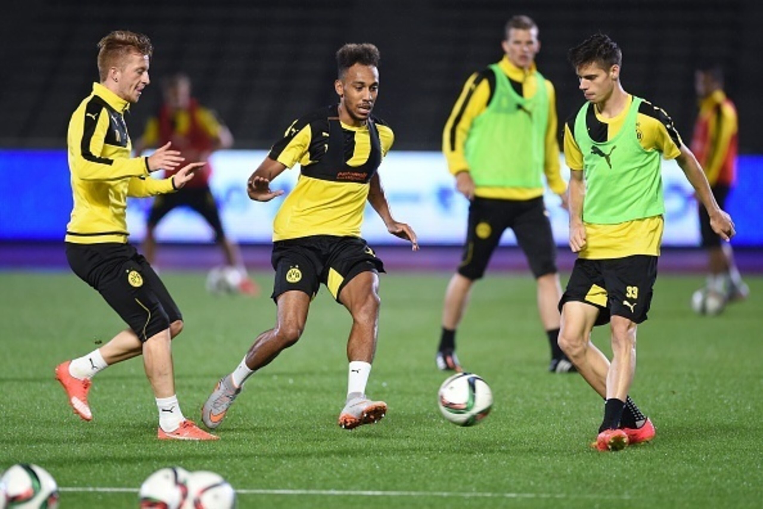 Midfielder Pierre-Emerick Aubameynag (2nd L) of Germany's football club Borussia Dortmund shoots a ball during a training session after their arrival in Japan in Kawasaki, suburb of Tokyo on July 6, 2015.  Borussia Dortmund will play a friendly match with