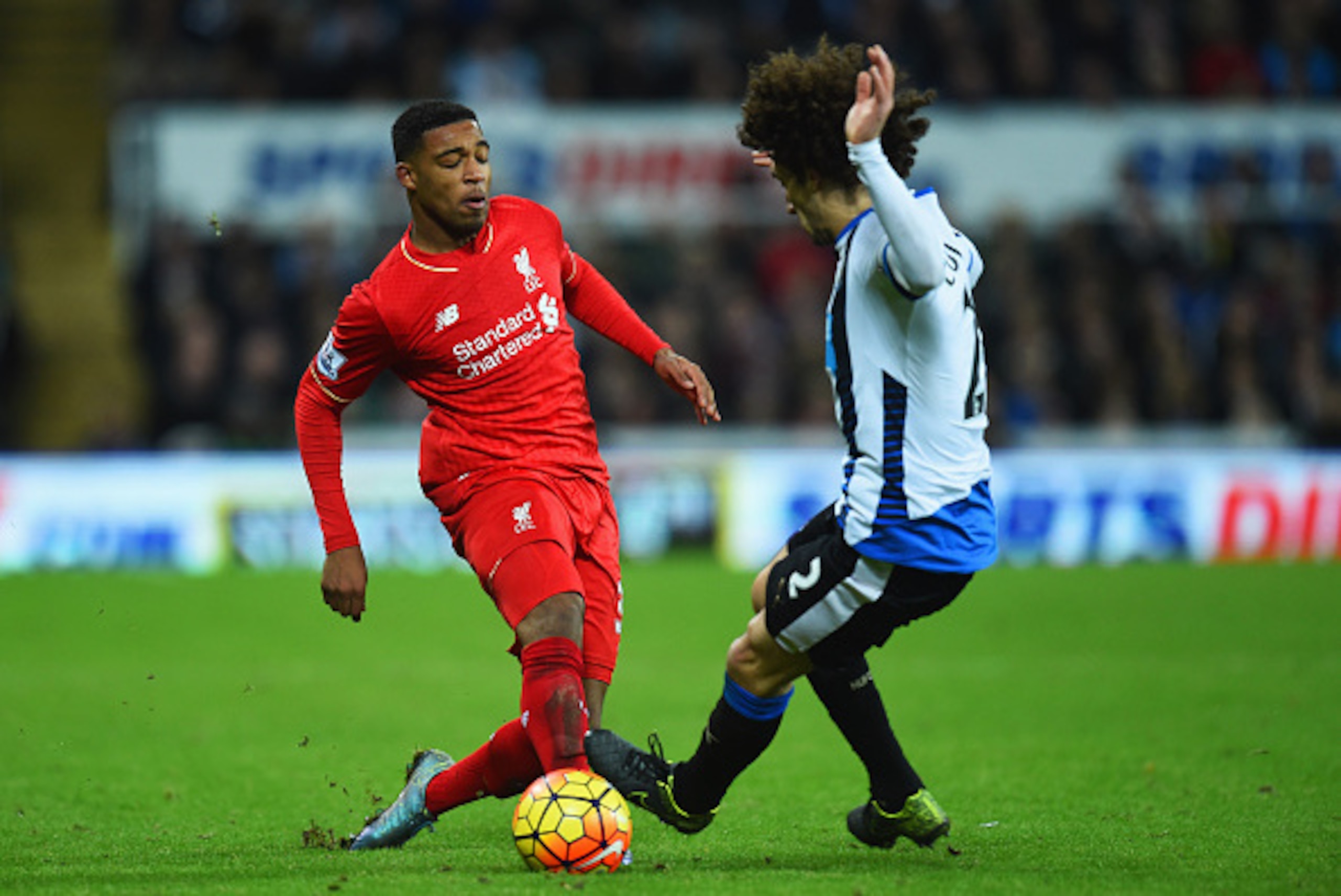 NEWCASTLE UPON TYNE, ENGLAND - DECEMBER 06:  Jordon Ibe of Liverpool takes on Fabricio Coloccini of Newcastle United during the Barclays Premier League match between Newcastle United and Liverpool at St James' Park on December 6, 2015 in Newcastle upon Ty