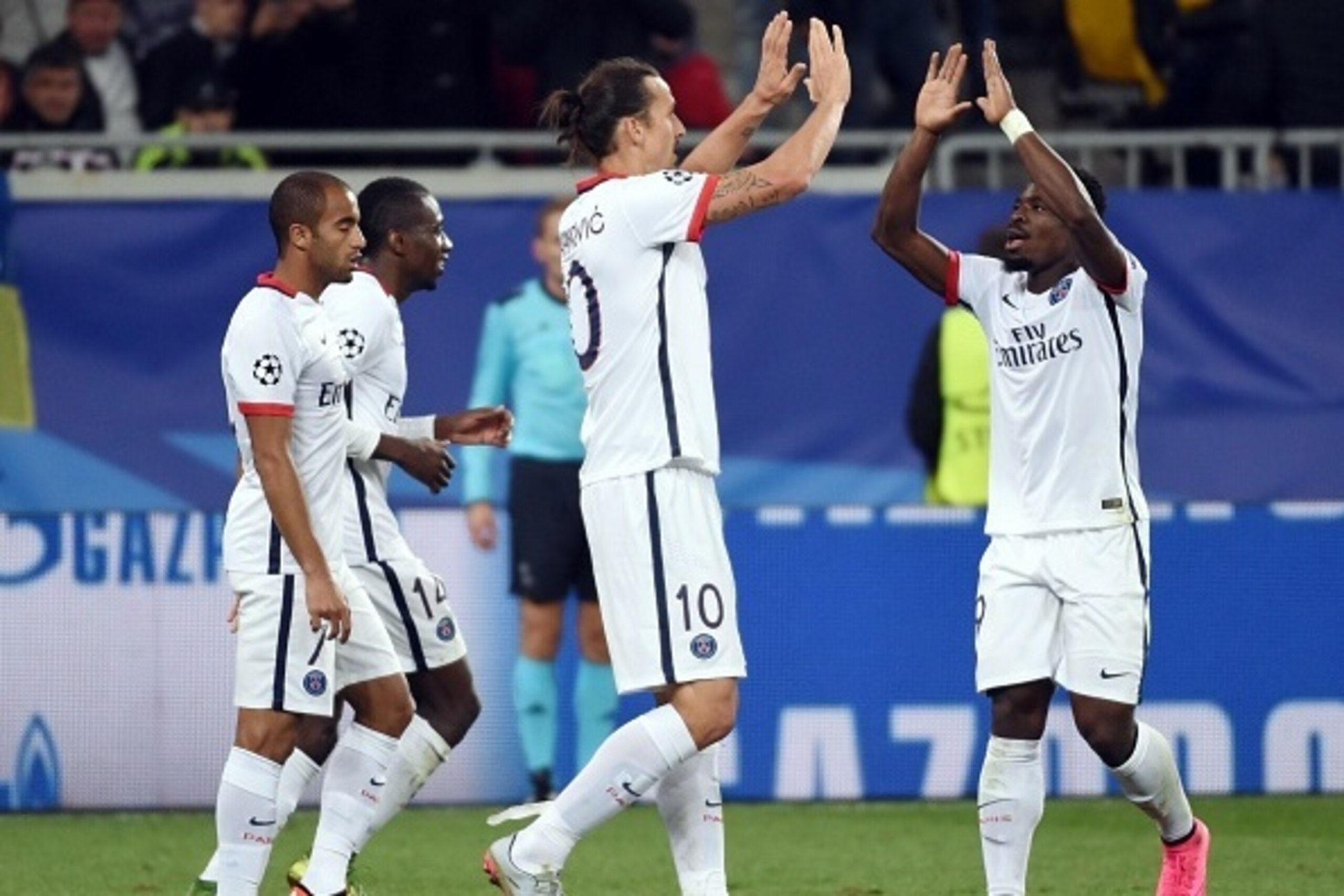 Paris Saint-Germain's Swedish forward Zlatan Ibrahimovic (C) celebrates with Paris Saint-Germain's Ivorian defender Serge Aurier during the UEFA Champions League group A football match between Shakhtar Donetsk and Paris Saint-Germain at the Arena Lviv, in