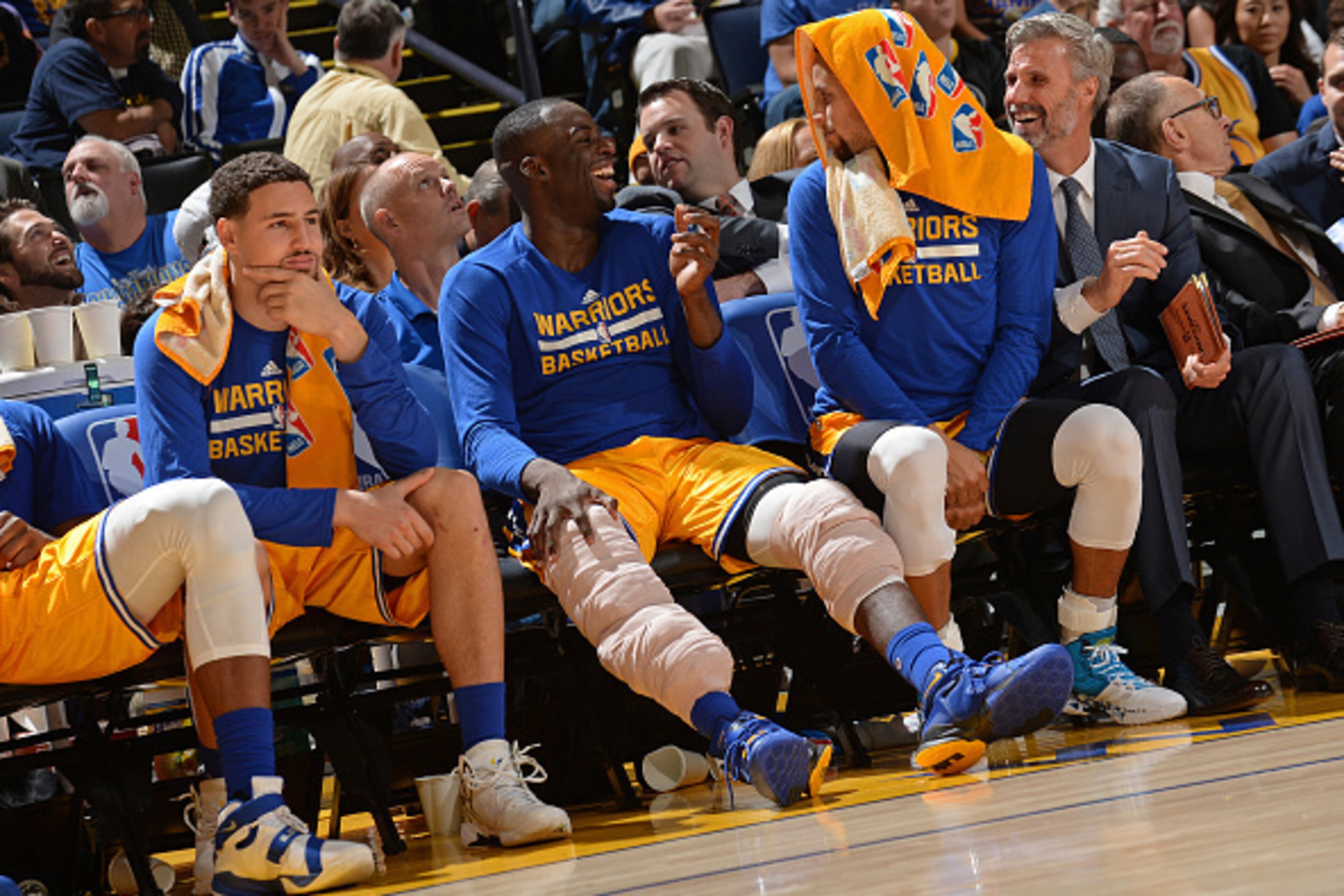 OAKLAND, CA - NOVEMBER 24:  Klay Thompson #11, Draymond Green #23 and Stephen Curry #30 of the Golden State Warriors sit on the bench during the game against the Los Angeles Lakers on November 24, 2015 at ORACLE Arena in Oakland, California. NOTE TO USER: