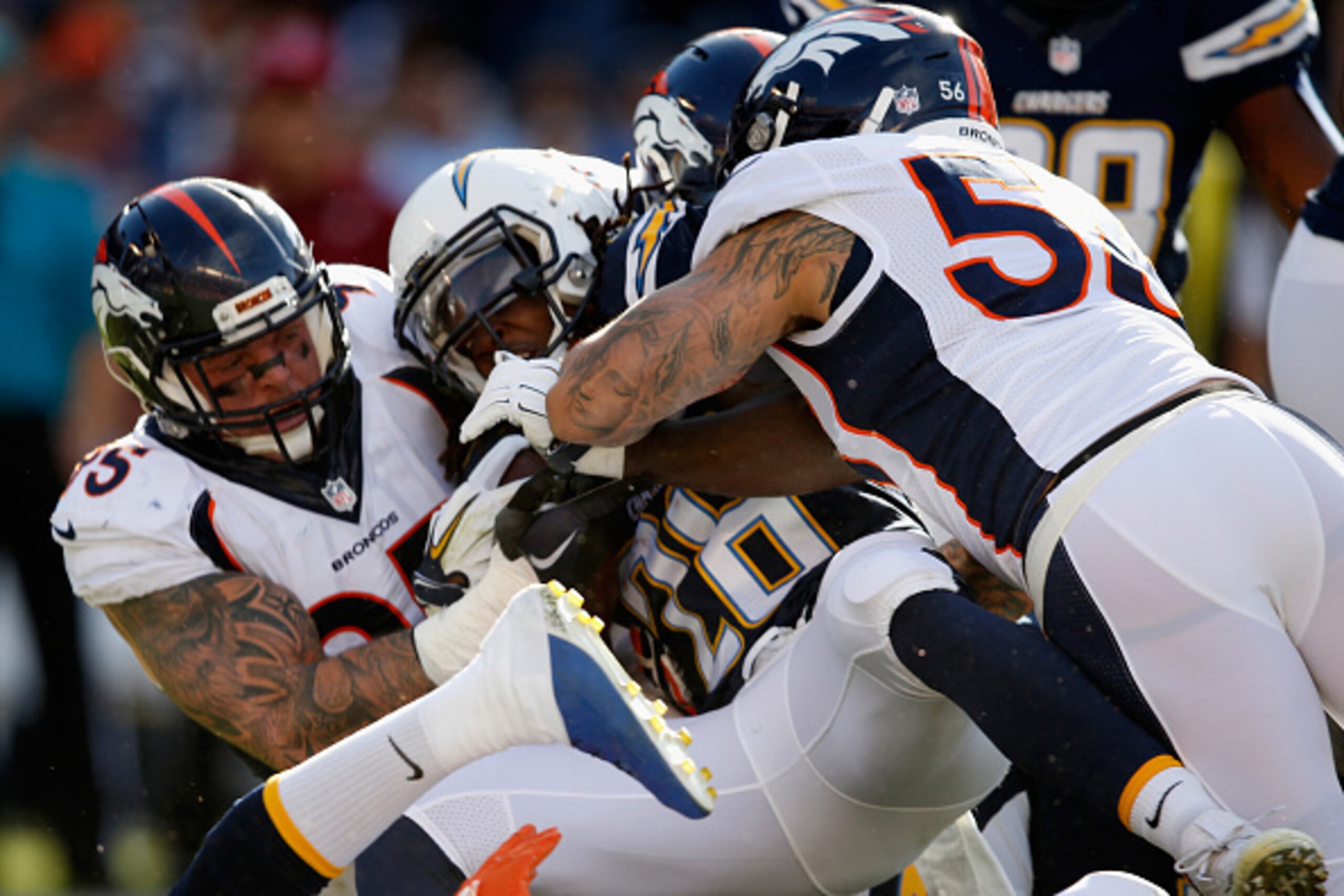 SAN DIEGO, CA - DECEMBER 06:   Derek Wolfe #95 of the Denver Broncos and  Shane Ray #56 of the Denver Broncos tackle  Melvin Gordon #28 of the San Diego Chargers during the first quarter of a game at Qualcomm Stadium on December 6, 2015 in San Diego, Cali