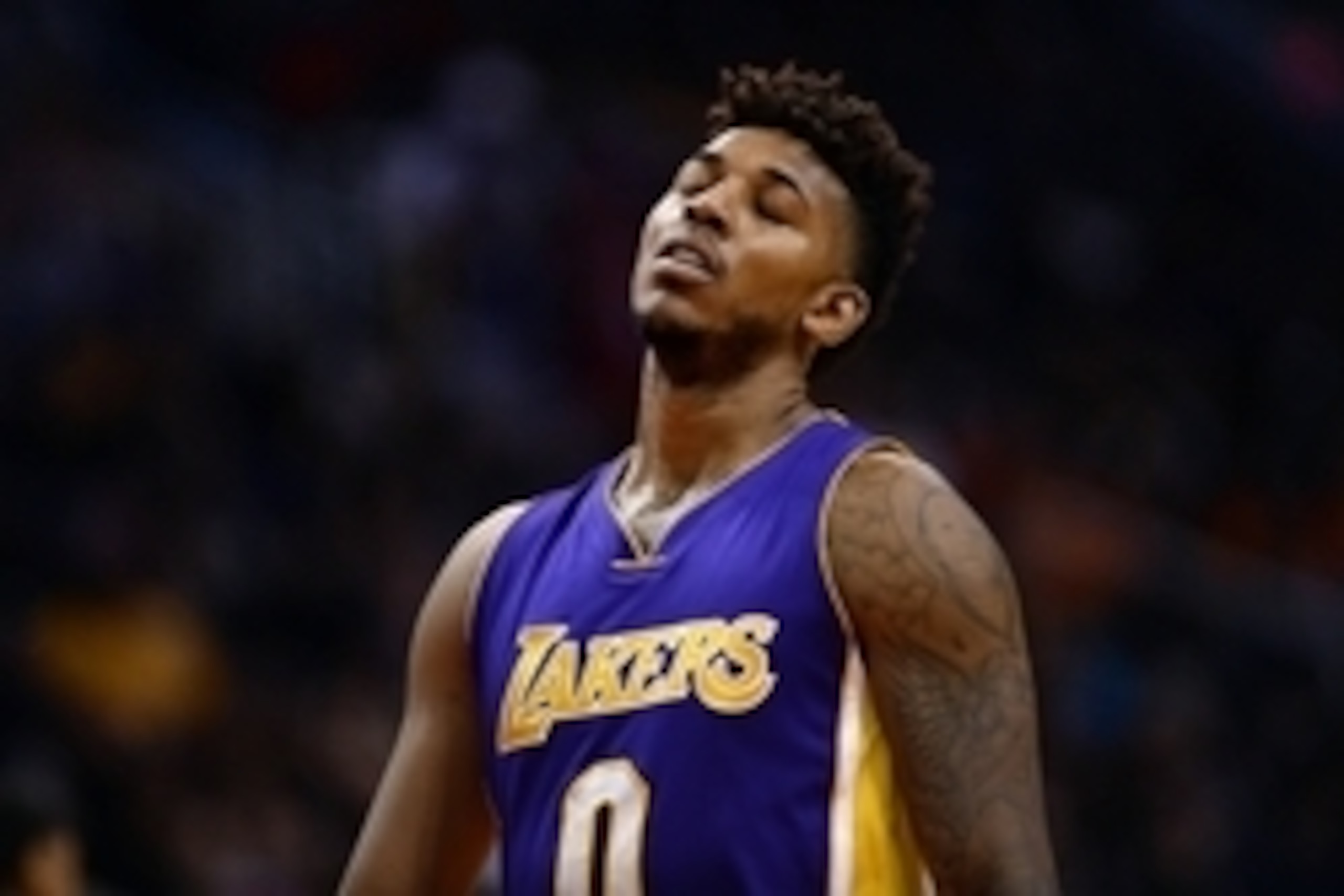 Nov 16, 2015; Phoenix, AZ, USA; Los Angeles Lakers forward Nick Young (0) reacts while walking up the court in first half of the NBA game against the Phoenix Suns at Talking Stick Resort Arena. Mandatory Credit: Jennifer Stewart-USA TODAY Sports