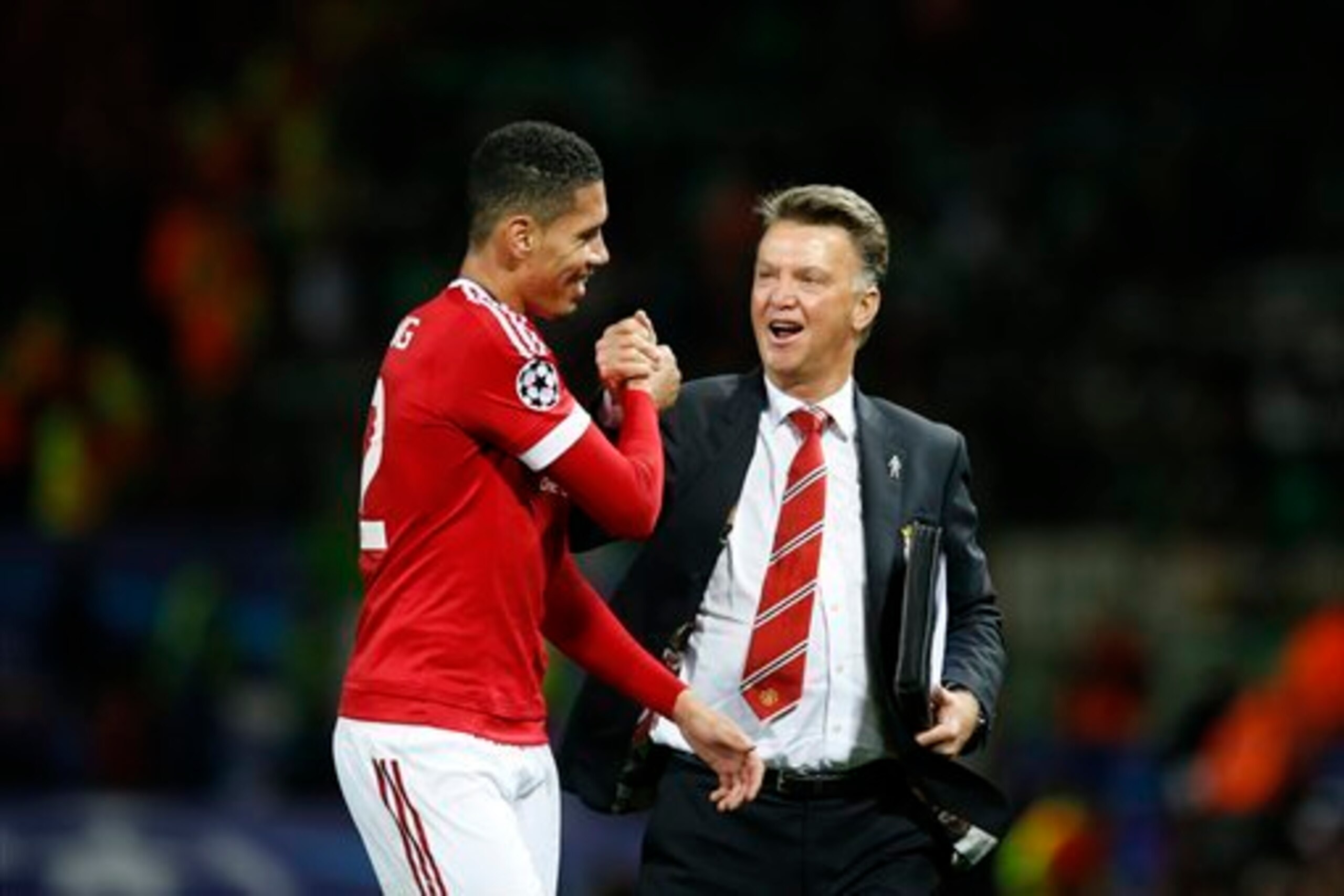 Smalling celebrates United's win over Wolfsburg at Old Trafford with Van Gaal.