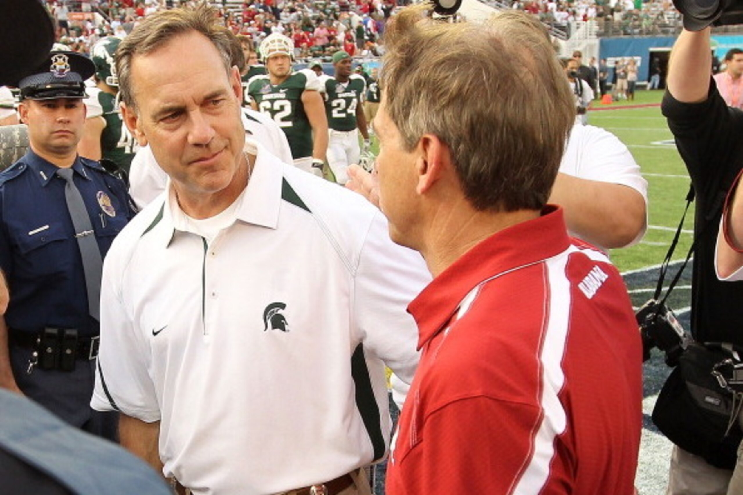 ORLANDO, FL - JANUARY 01:  Alabama Crimson Tide Head Coach Nick Saban greets Michigan State Spartans Head Coach Mark Dantonio after winning the Capitol One Bowl against at the Florida Citrus Bowl on January 1, 2011 in Orlando, Florida.  (Photo by Mike Ehr