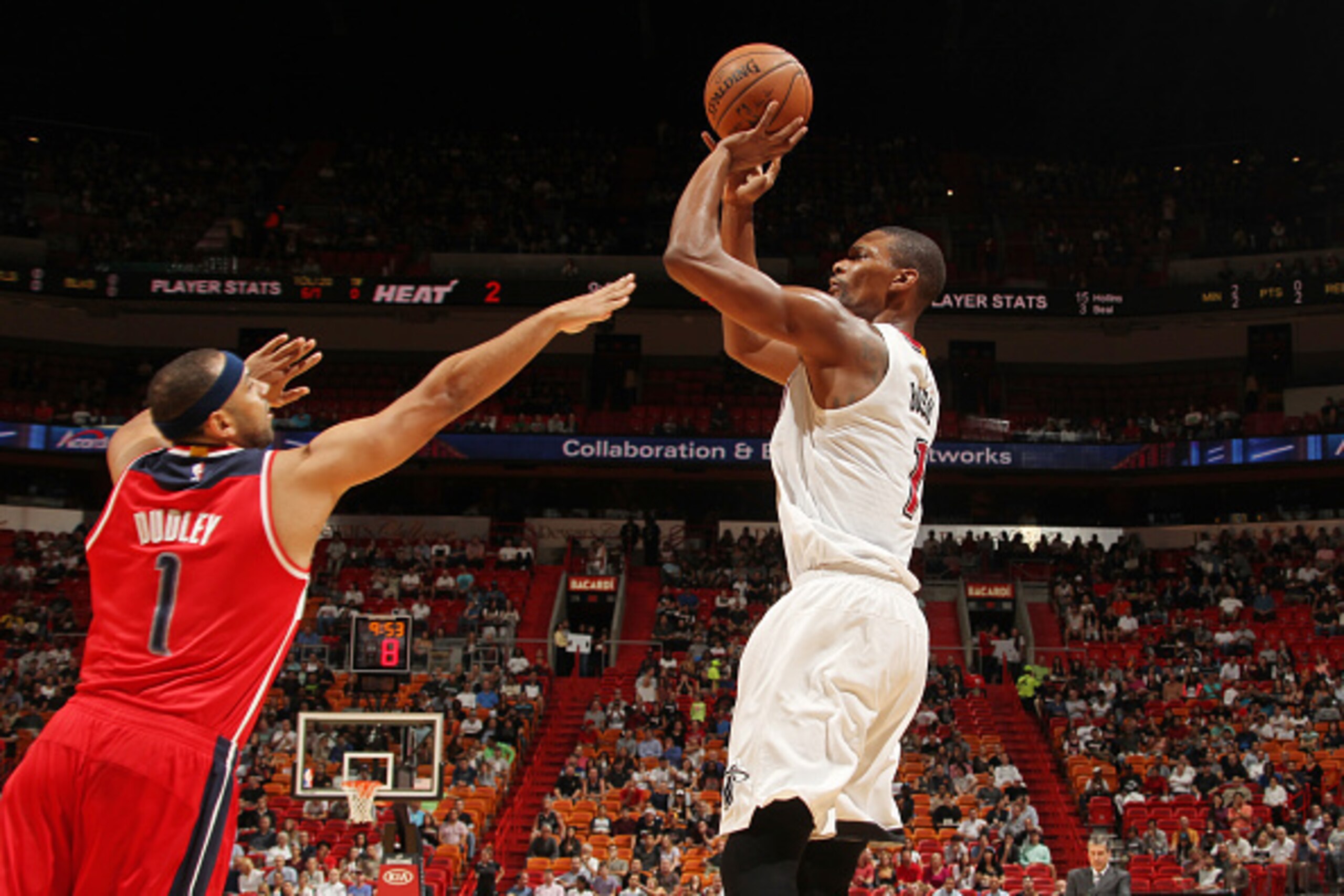 MIAMI, FL - DECEMBER 7: Chris Bosh #1 of the Miami Heat shoots against Jared Dudley #1 of the Washington Wizards during the game on December 7, 2015 at American Airlines Arena in Minneapolis, Florida. NOTE TO USER: User expressly acknowledges and agrees t
