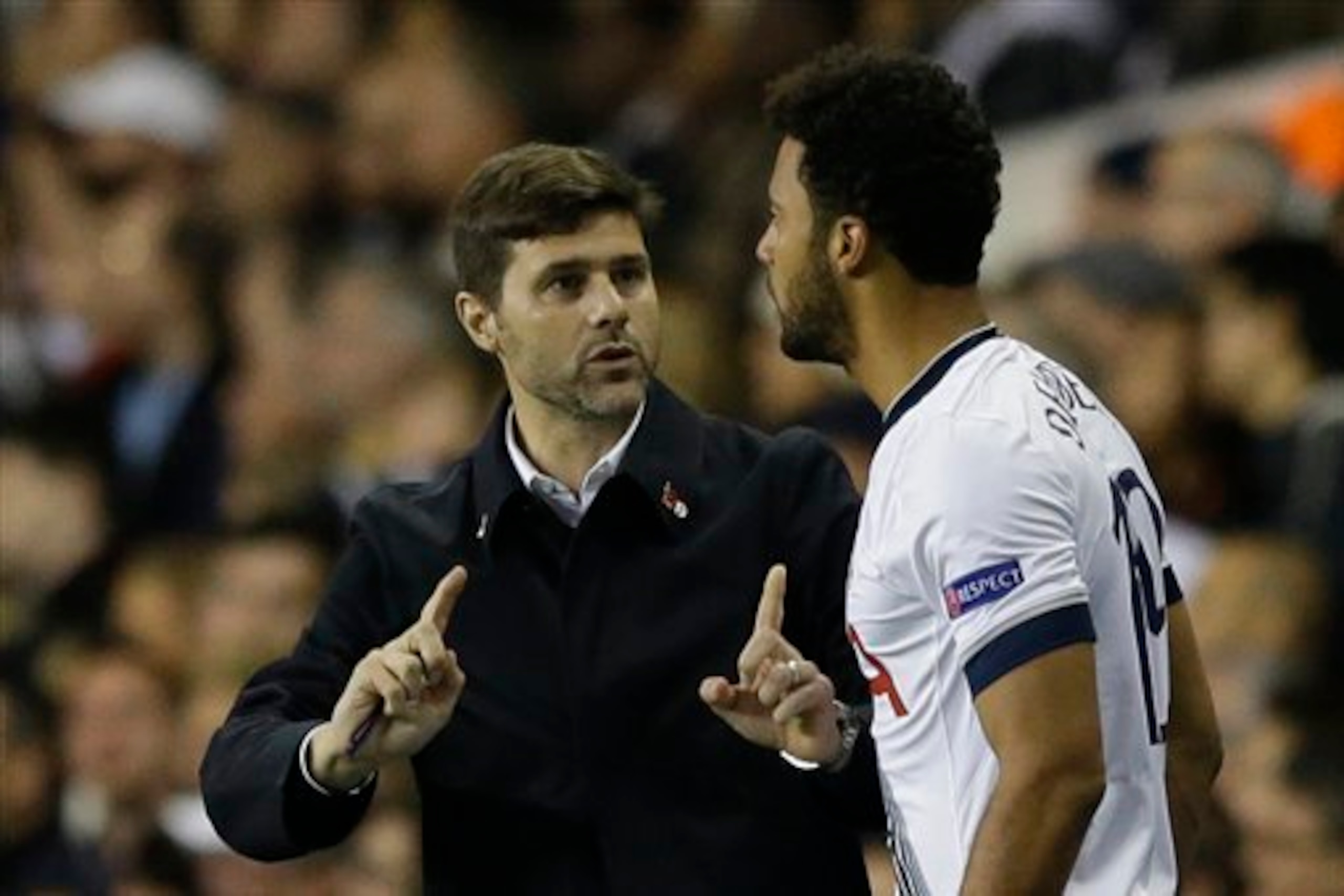 Dembele in discussion with Mauricio Pochettino prior to his introduction during Tottenham's recent Europa League win over Anderlecht. The substitute would score the game's deciding goal.