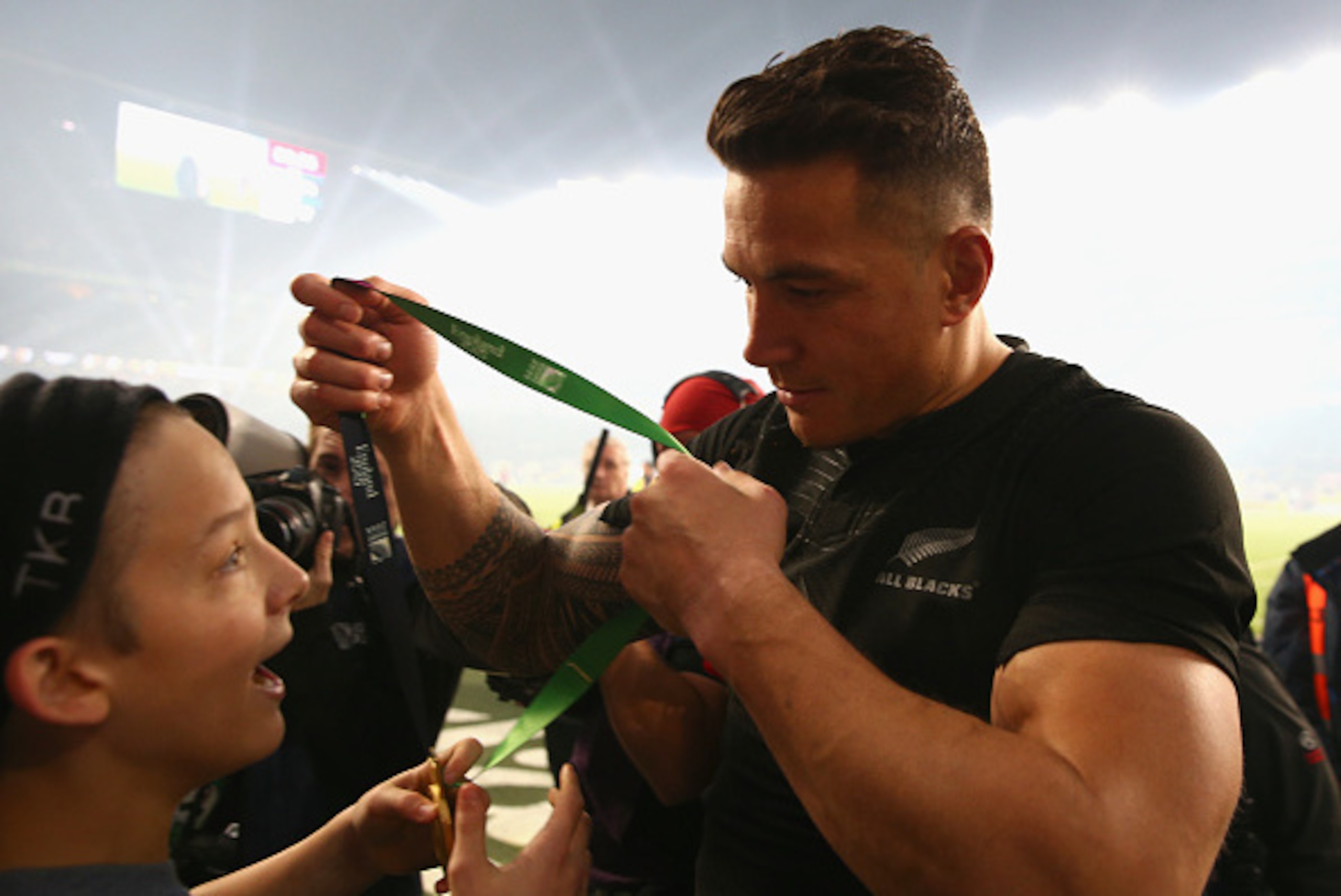 LONDON, ENGLAND - OCTOBER 31:  Sonny Bill Williams of New Zealand hands his medal to young fan Charlie Lines after winning the 2015 Rugby World Cup Final match between New Zealand and Australia at Twickenham Stadium on October 31, 2015 in London, United K