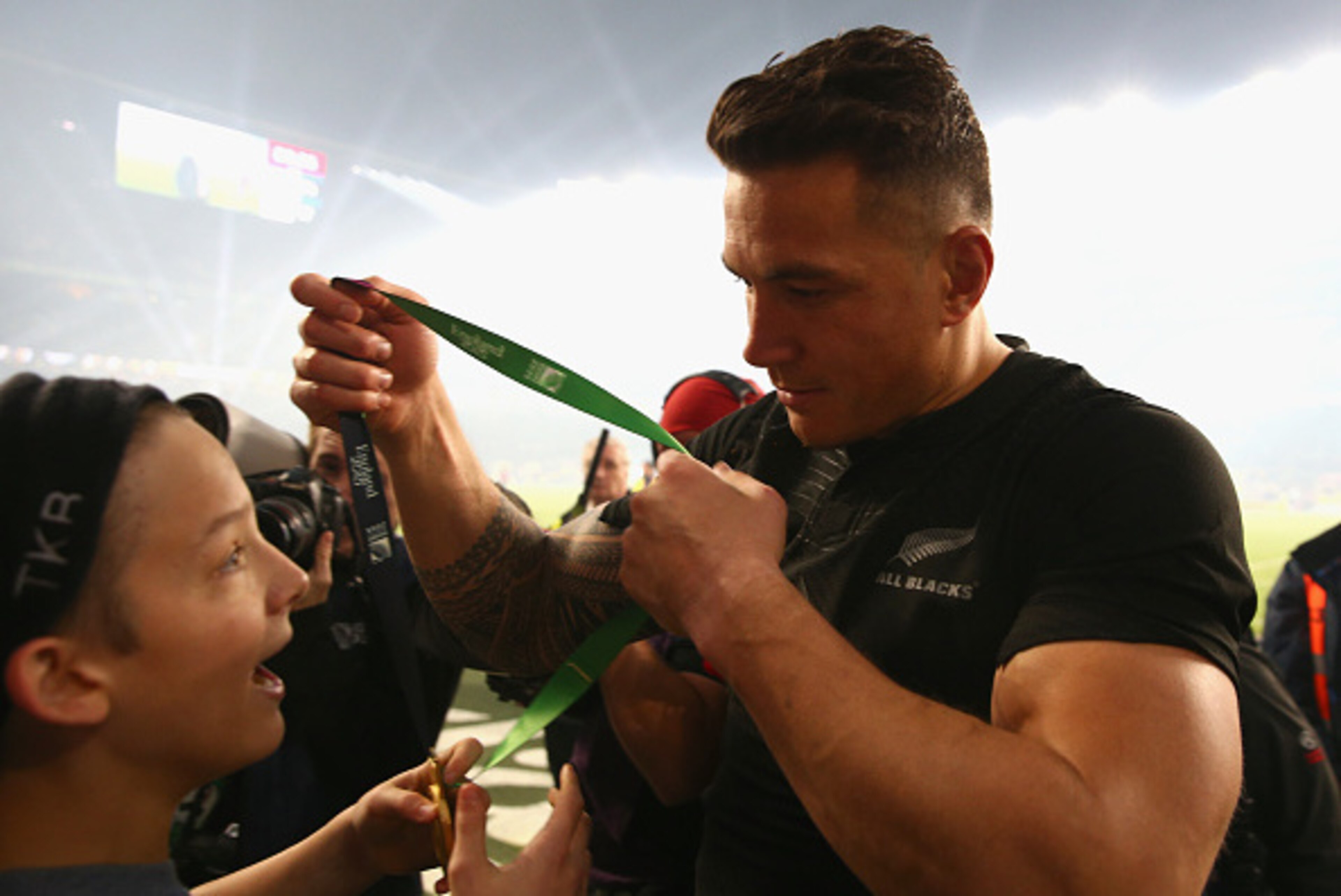LONDON, ENGLAND - OCTOBER 31:  Sonny Bill Williams of New Zealand hands his medal to young fan Charlie Lines after winning the 2015 Rugby World Cup Final match between New Zealand and Australia at Twickenham Stadium on October 31, 2015 in London, United K