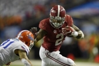 Dec 5, 2015; Atlanta, GA, USA; Alabama Crimson Tide running back Derrick Henry (2) runs against Florida Gators defensive back Jalen Tabor (31) during the third quarter of the 2015 SEC Championship Game at the Georgia Dome. Mandatory Credit: John David Mer