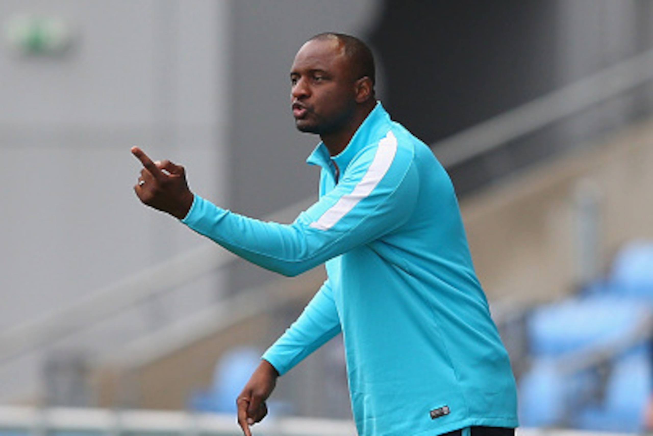 MANCHESTER, ENGLAND - AUGUST 14: Patrick Vieira the coach of Manchester City U21 shouts instructions to his players during the Barclays U21 Premier League match between Manchester City U21 and Tottenham Hotspur U21 at The Academy Stadium on August 14, 20 MANCHESTER, ENGLAND - AUGUST 14: Patrick Vieira the coach of Manchester City U21 shouts instructions to his players during the Barclays U21 Premier League match between Manchester City U21 and Tottenham Hotspur U21 at The Academy Stadium on August 14, 20