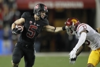 Dec 5, 2015; Santa Clara, CA, USA; Stanford Cardinal running back Christian McCaffrey (5) tries to avoid being tackled by Southern California Trojans cornerback Kevon Seymour (13) after running for a first down in the second quarter in the Pac-12 Conferen