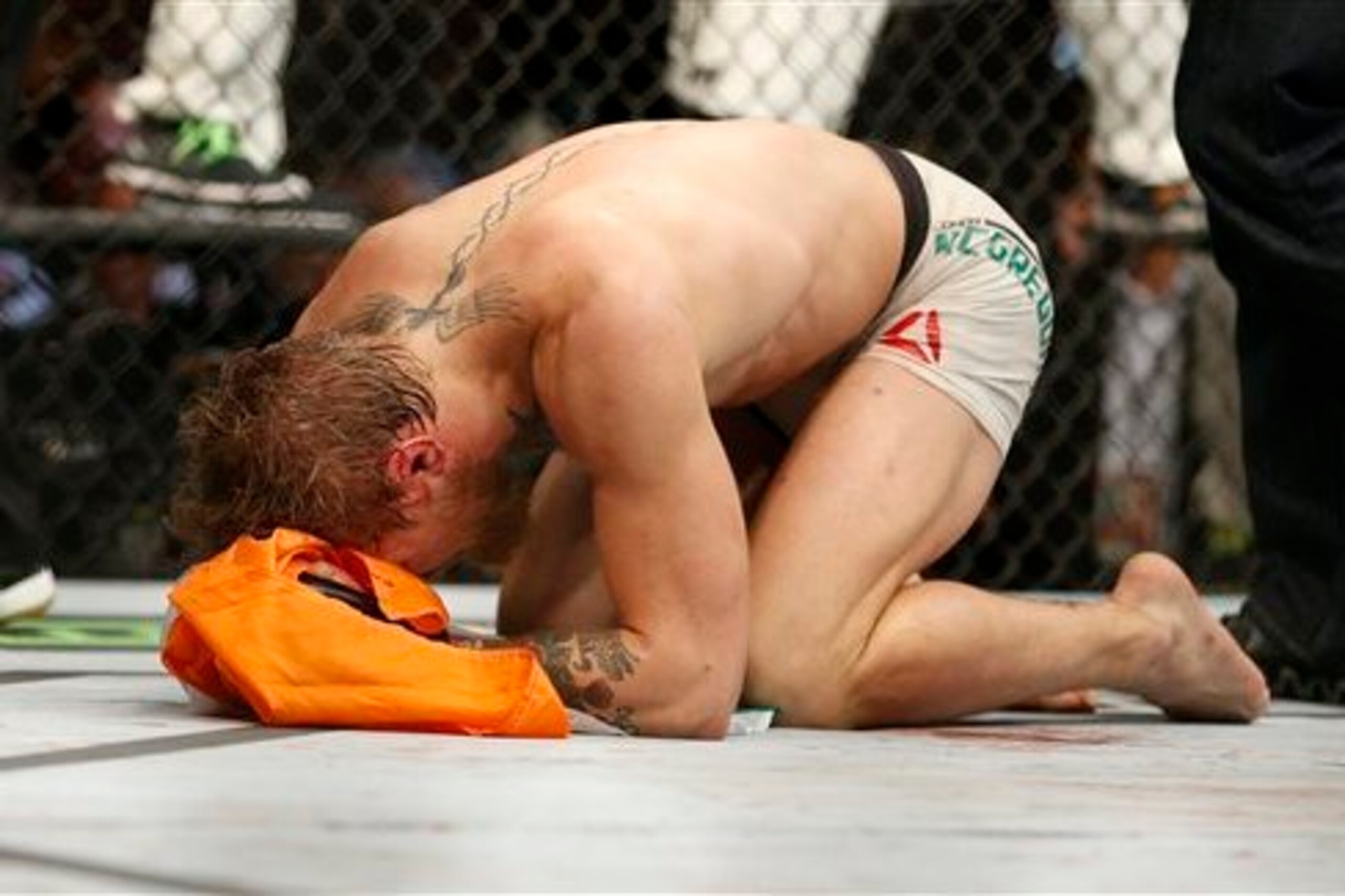 McGregor kneels in the Octagon after UFC 189 win McGregor kneels in the Octagon after UFC 189 win