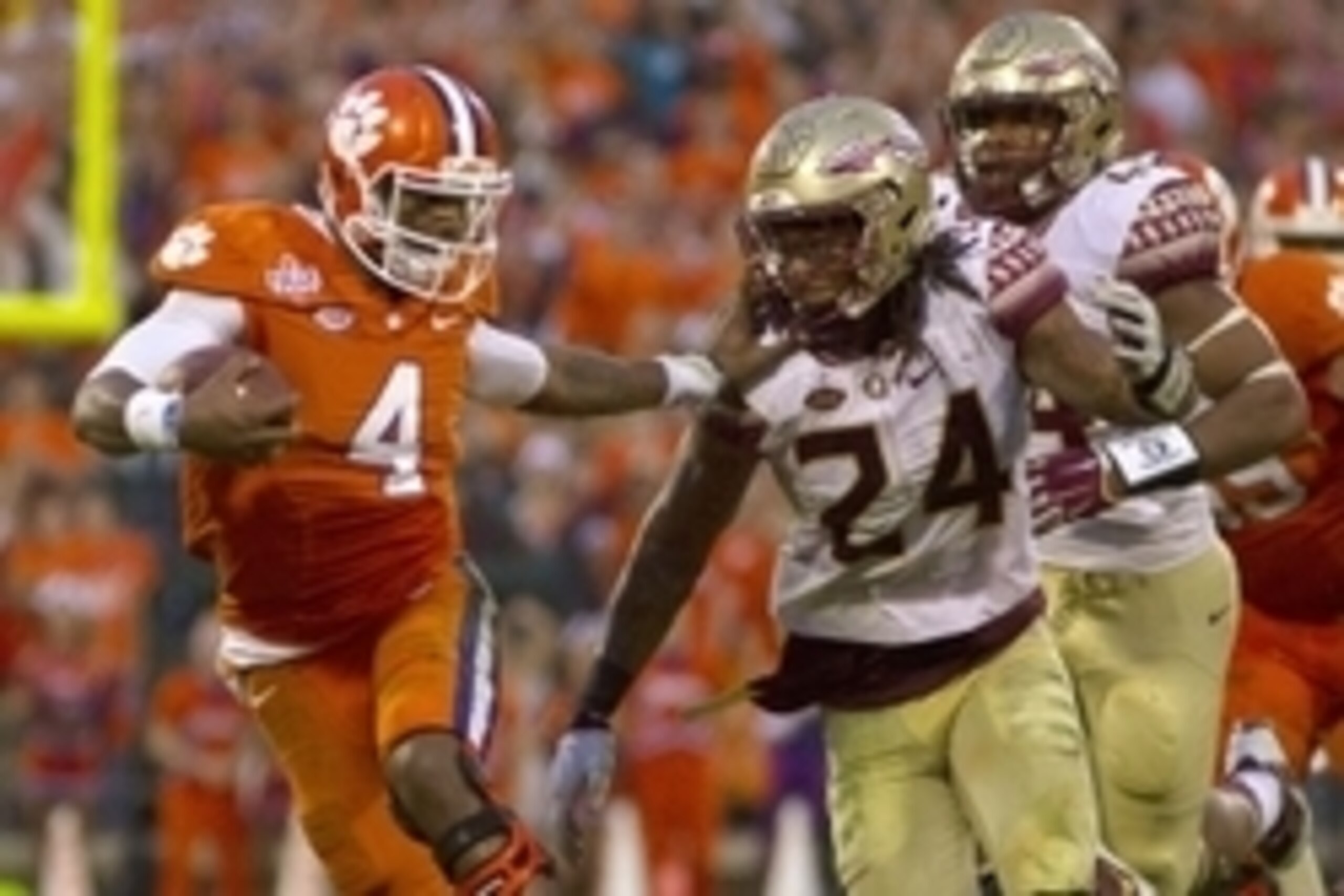 Nov 7, 2015; Clemson, SC, USA; Clemson Tigers quarterback Deshaun Watson (4) carries the ball while being defended by Florida State Seminoles linebacker Terrance Smith (24) during the first half at Clemson Memorial Stadium. Mandatory Credit: Joshua S. Kel Nov 7, 2015; Clemson, SC, USA; Clemson Tigers quarterback Deshaun Watson (4) carries the ball while being defended by Florida State Seminoles linebacker Terrance Smith (24) during the first half at Clemson Memorial Stadium. Mandatory Credit: Joshua S. Kel